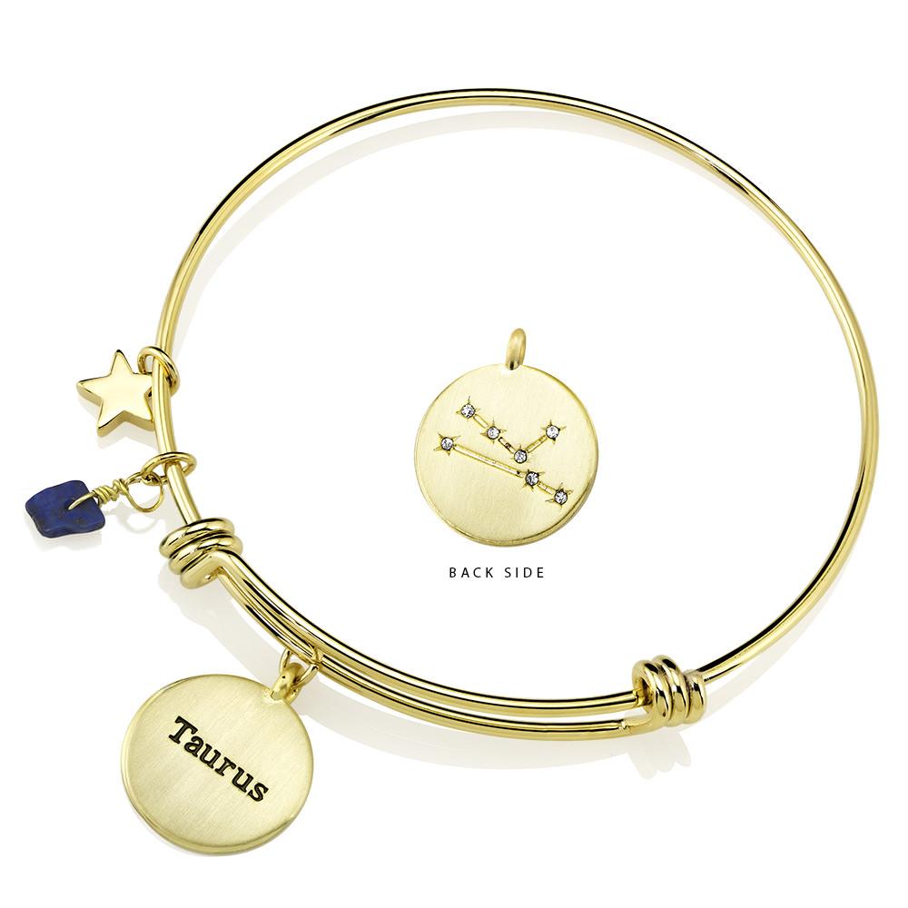 Elegant gold-plated bangle featuring zodiac charms and simulated diamonds, perfect for astrology lovers.