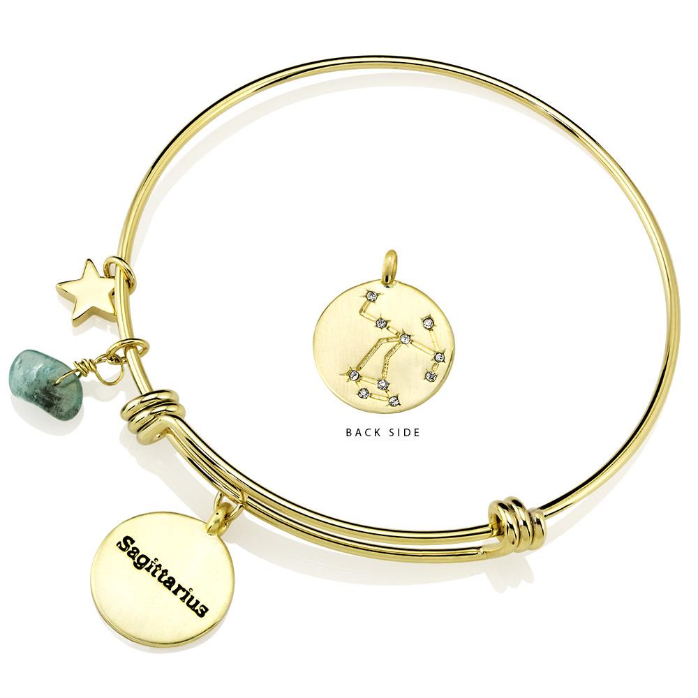 Elegant gold-plated bangle featuring zodiac charms and simulated diamonds, perfect for astrology lovers.