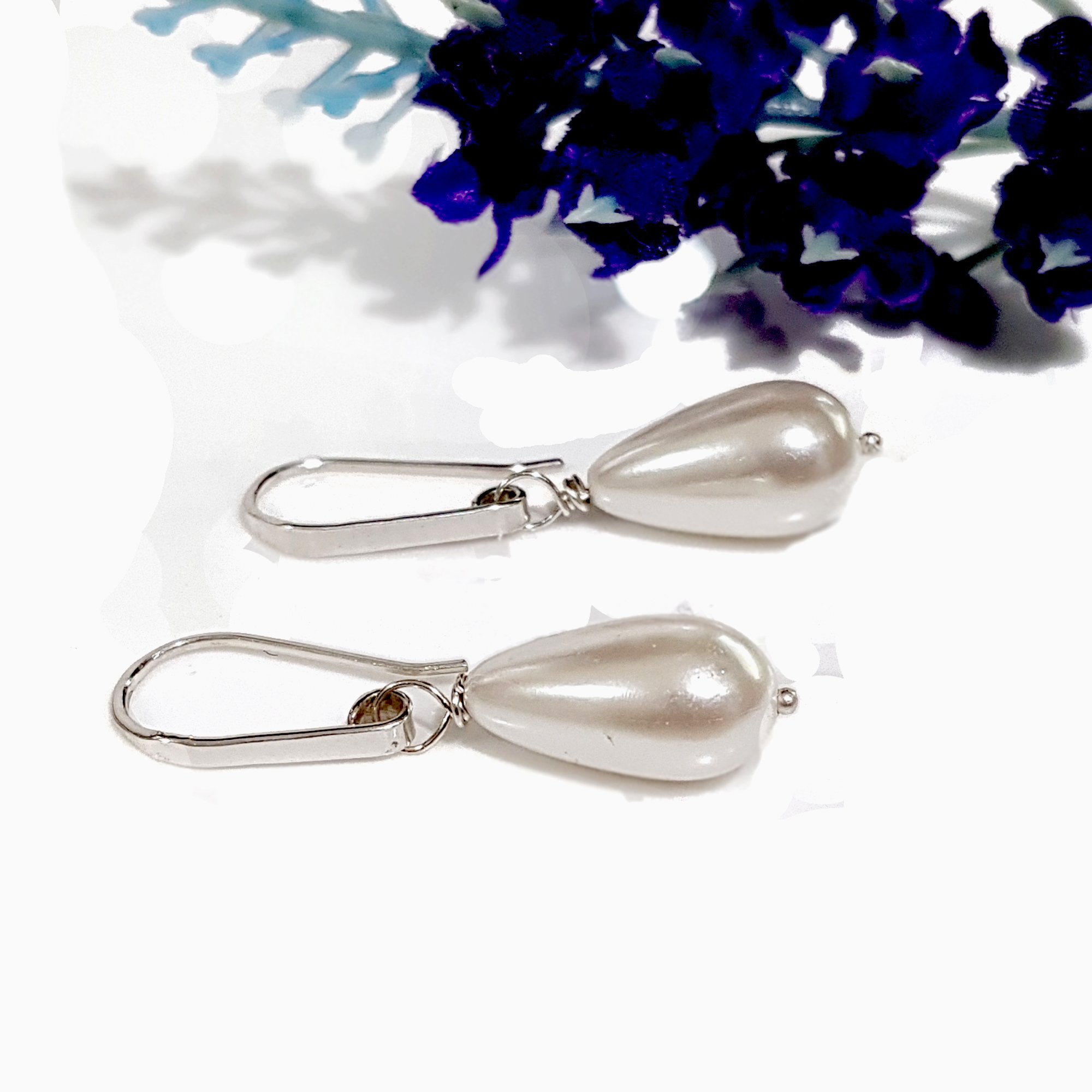 Elegant Dew Drop earrings featuring teardrop shell pearls on artisan hooks, perfect for bridal and formal occasions.