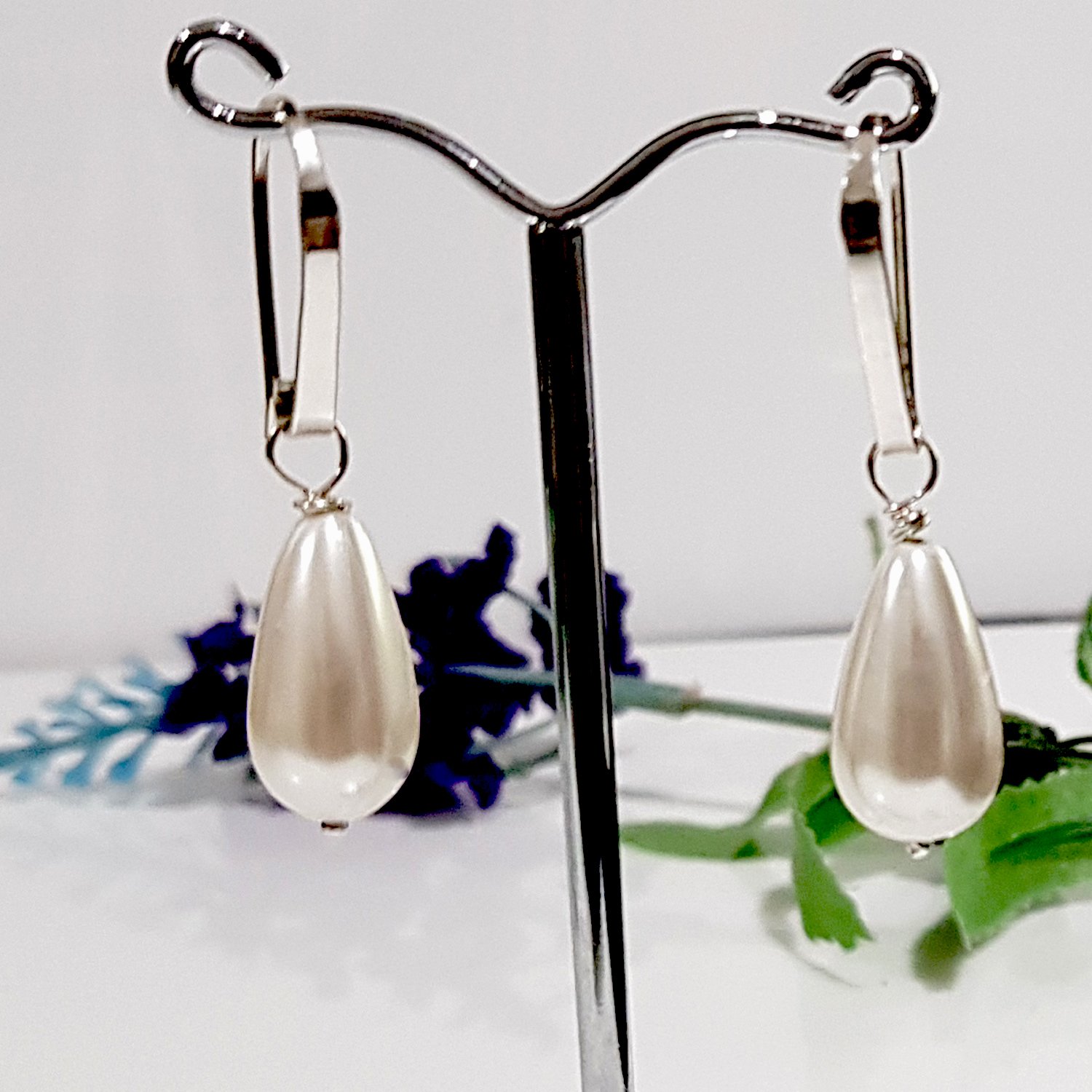 Elegant Dew Drop earrings featuring teardrop shell pearls on artisan hooks, perfect for bridal and formal occasions.