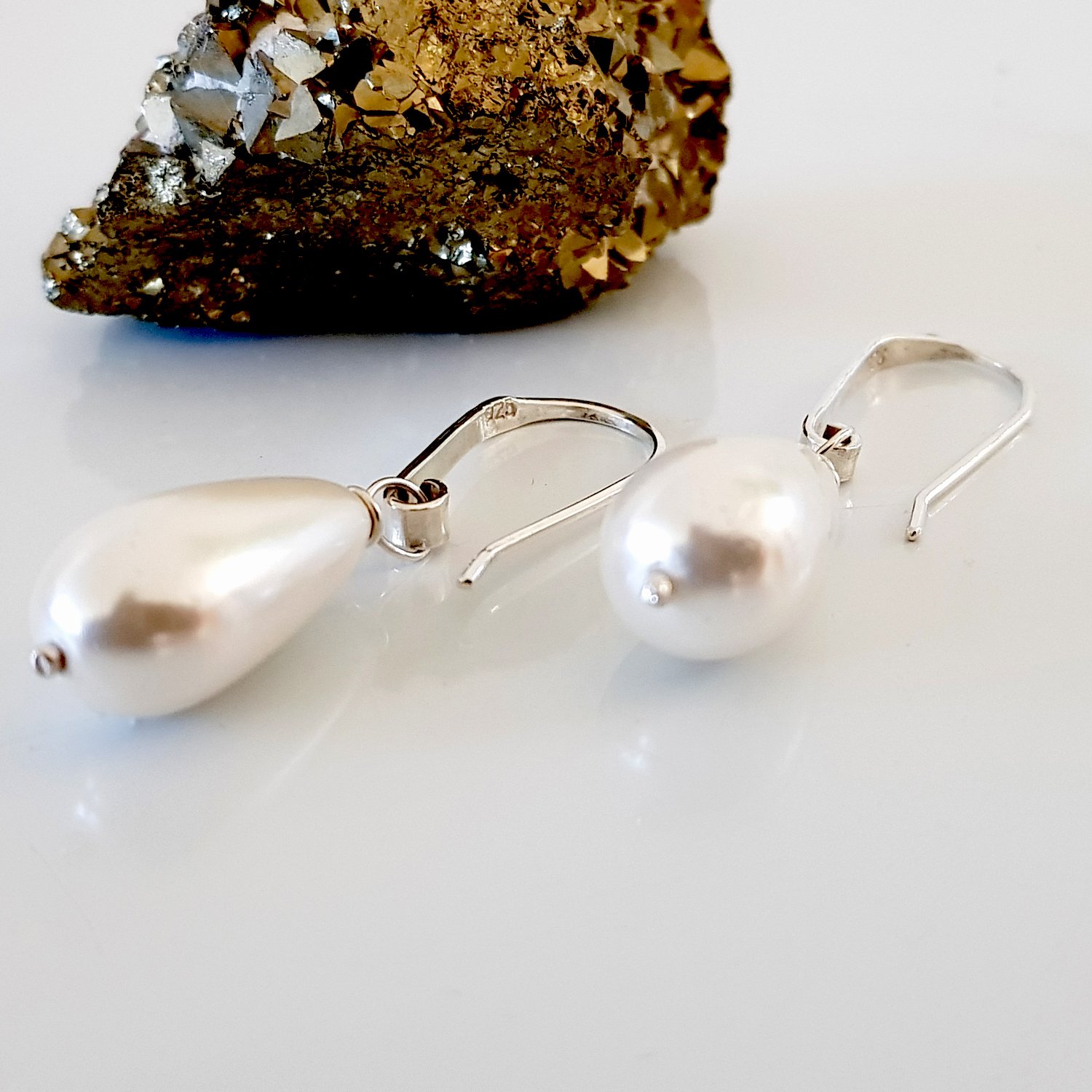 Elegant Dew Drop earrings featuring teardrop shell pearls on artisan hooks, perfect for bridal and formal occasions.