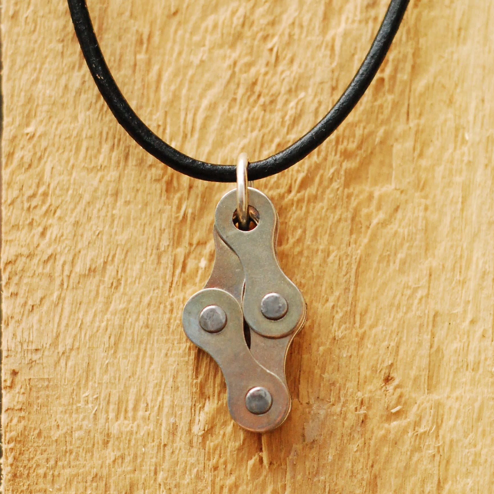 Diamond Recycled Bike Chain Pendant Necklace with leather cord, showcasing unique handmade design and eco-friendly materials.