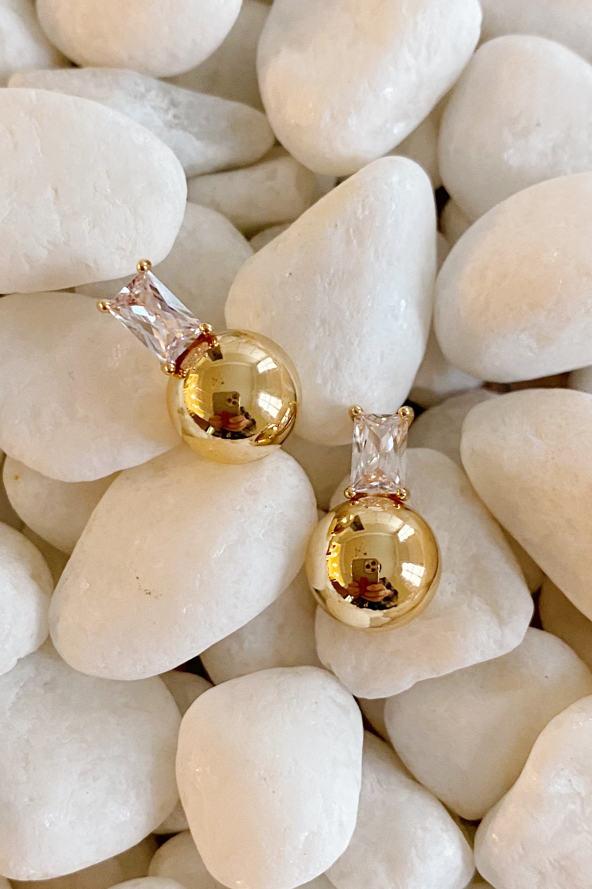 Diana's Golden Ball Stud Earrings featuring sparkling Cubic Zirconia and elegant gold plating, showcasing their beautiful design.