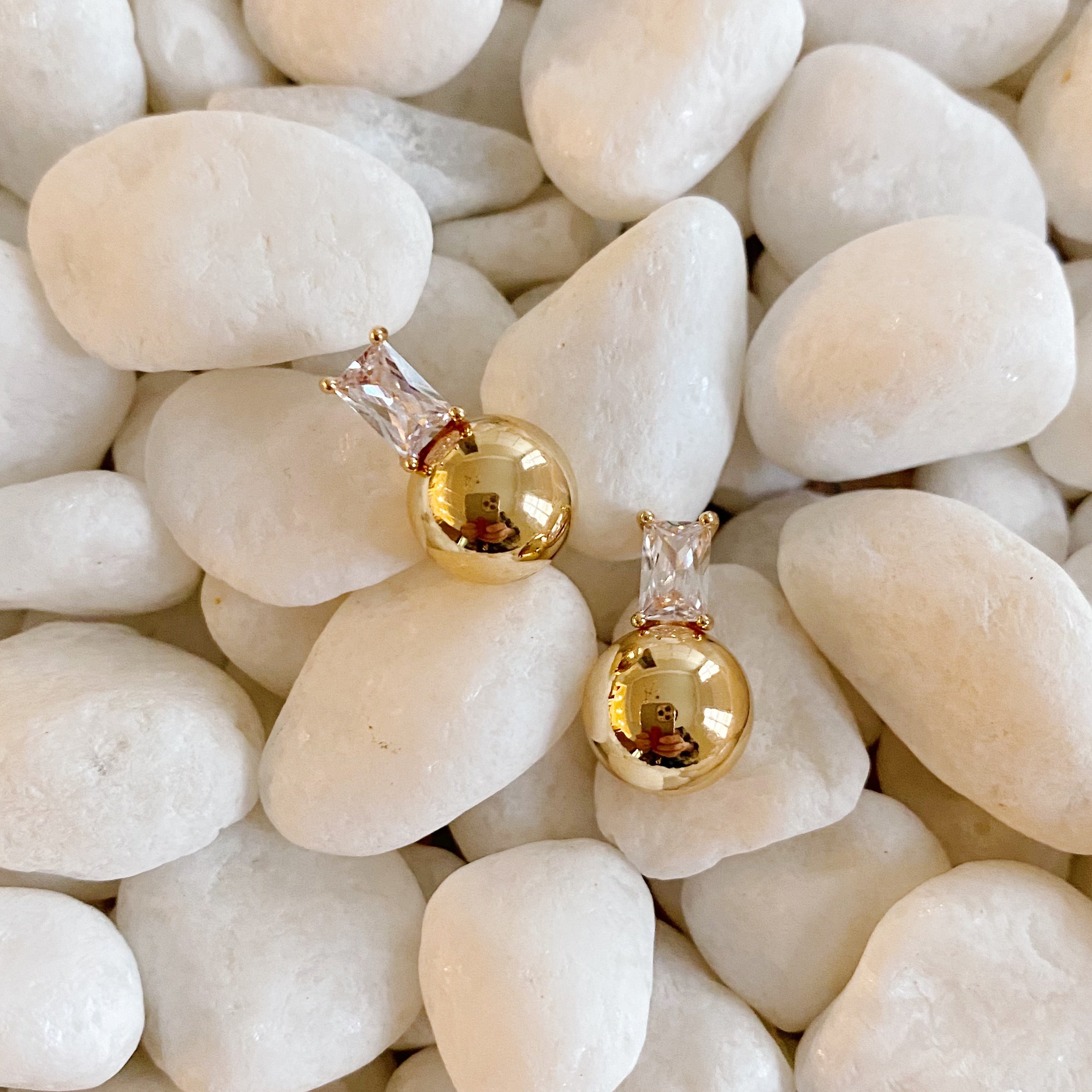 Diana's Golden Ball Stud Earrings featuring sparkling Cubic Zirconia and elegant gold plating, showcasing their beautiful design.