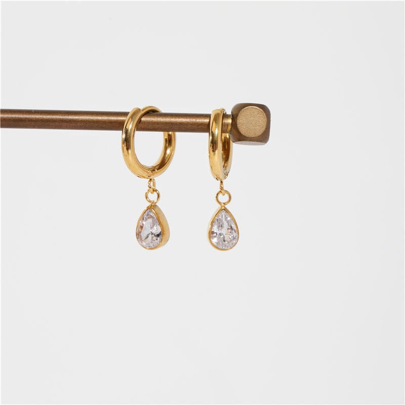 Dill Teardrop Crystal Charm Hoops featuring a polished design with a dangling clear crystal charm, perfect for stylish accessorizing.