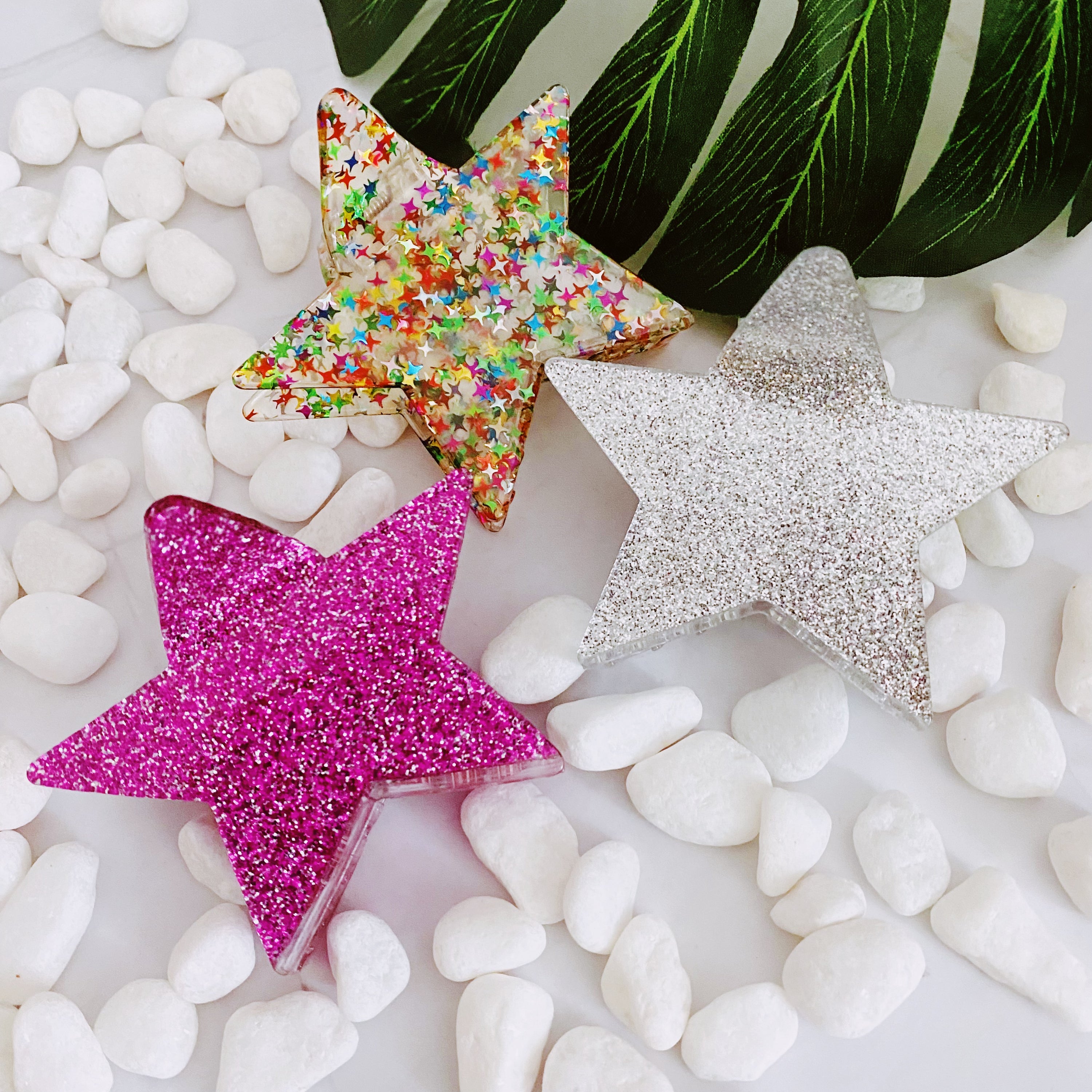 A glittery star-shaped hair claw in sparkling colors, perfect for festive hairstyles.