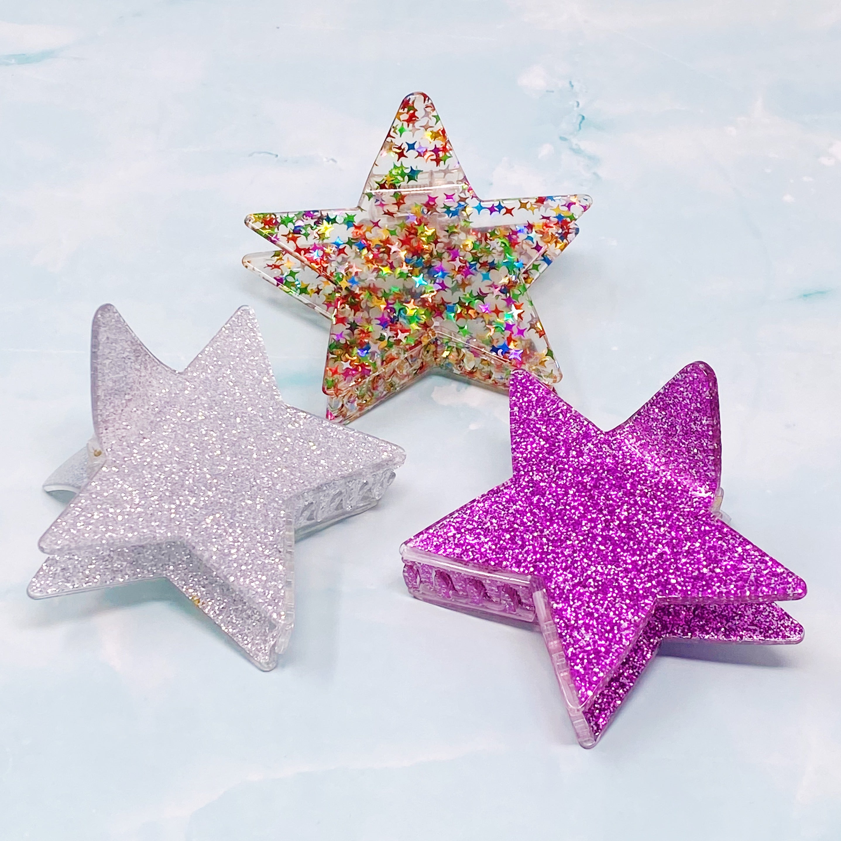 A glittery star-shaped hair claw in sparkling colors, perfect for festive hairstyles.