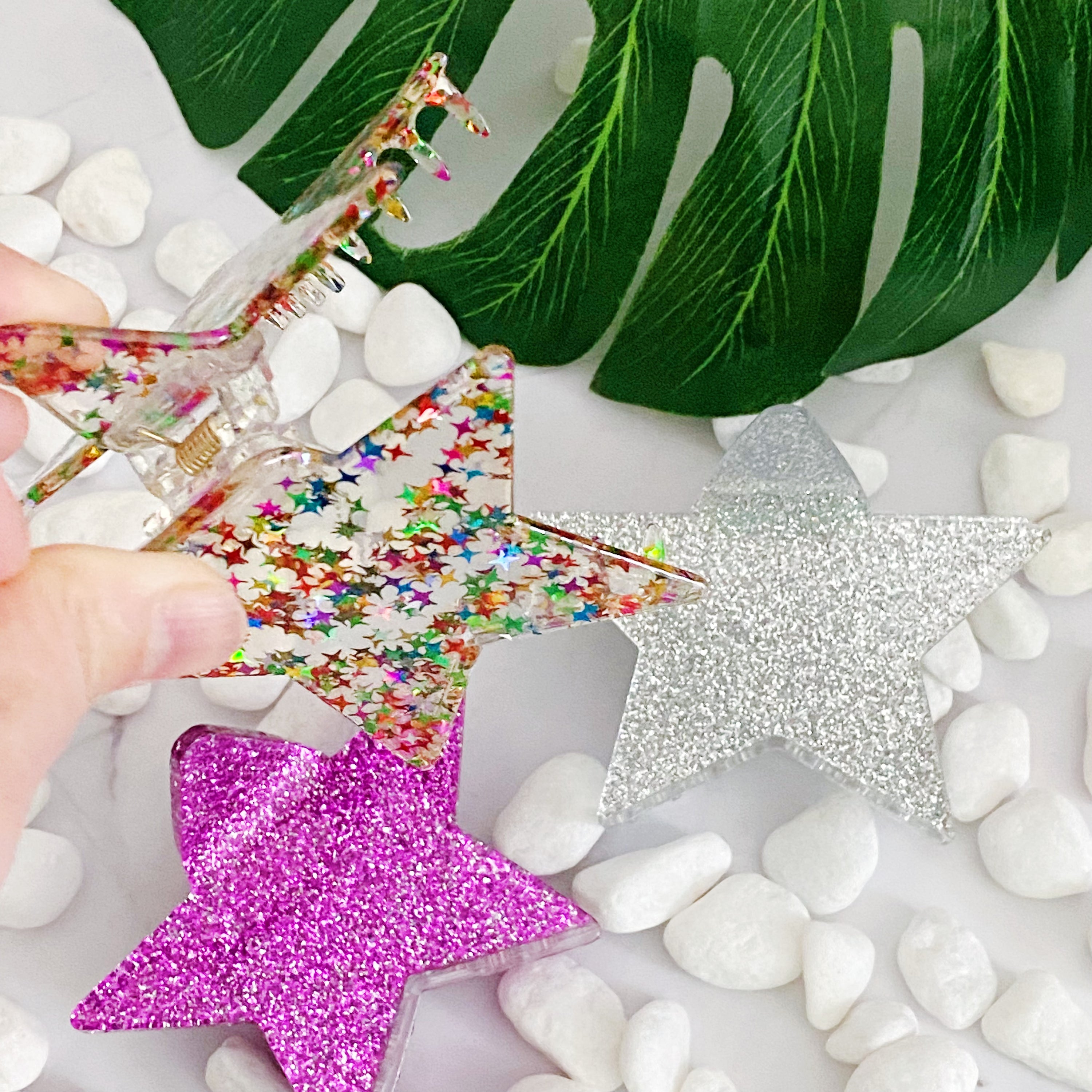 A glittery star-shaped hair claw in sparkling colors, perfect for festive hairstyles.