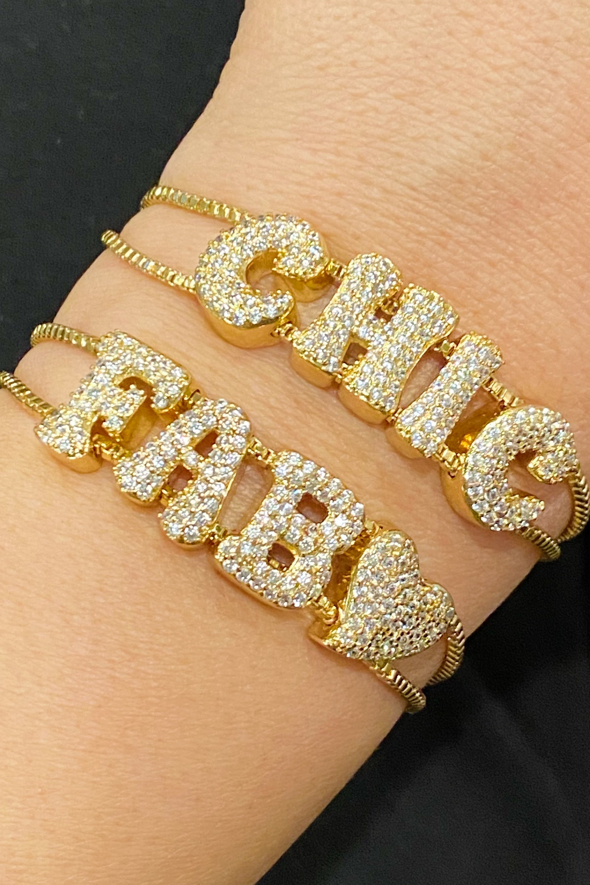 A sparkling Disco Dazzle Bracelet featuring a fun font design and adjustable drawstring chain, embellished with cubic zirconia accents.