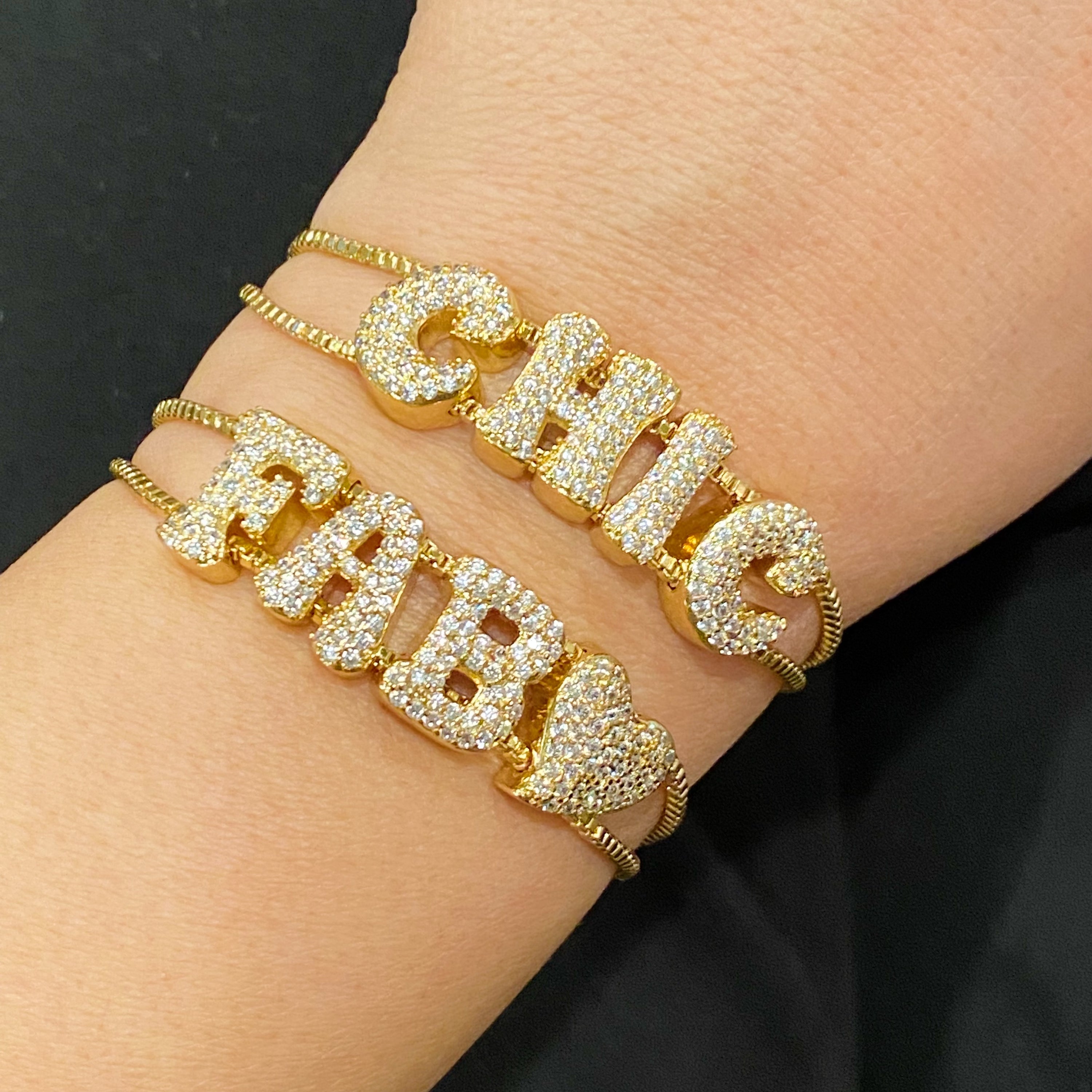 A sparkling Disco Dazzle Bracelet featuring a fun font design and adjustable drawstring chain, embellished with cubic zirconia accents.