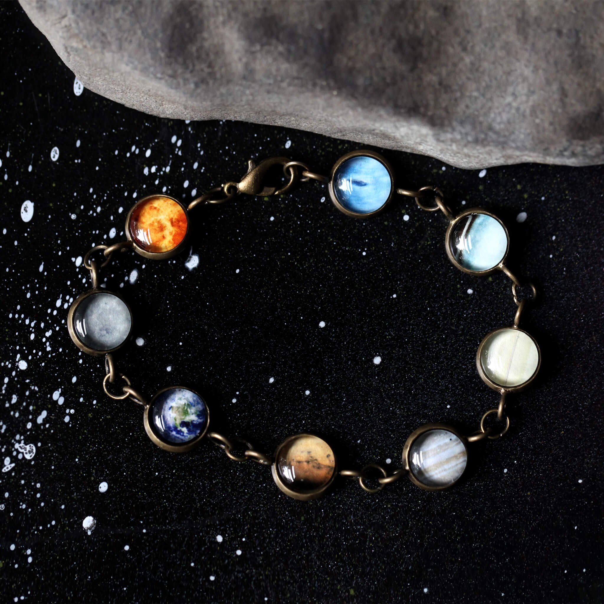 Solar System Galaxy Bracelet featuring planets in antique silver and bronze tones, handcrafted with plated brass and glass.