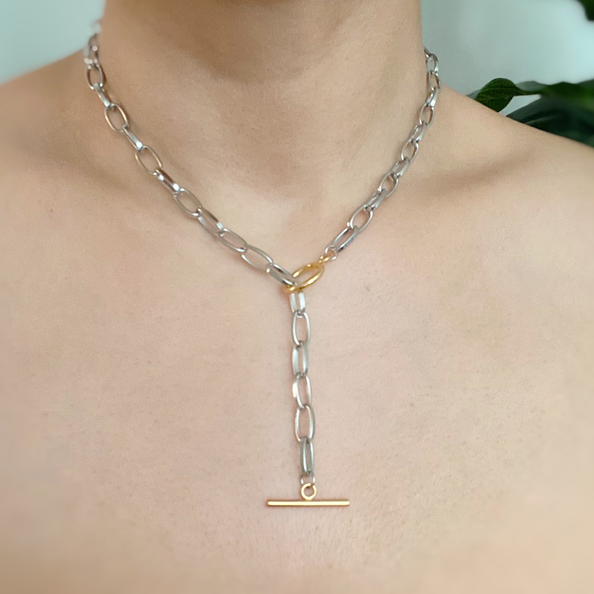 A stylish Do It All Link Chain Necklace featuring a two-tone design in silver and gold, adjustable length, and a toggle closure.