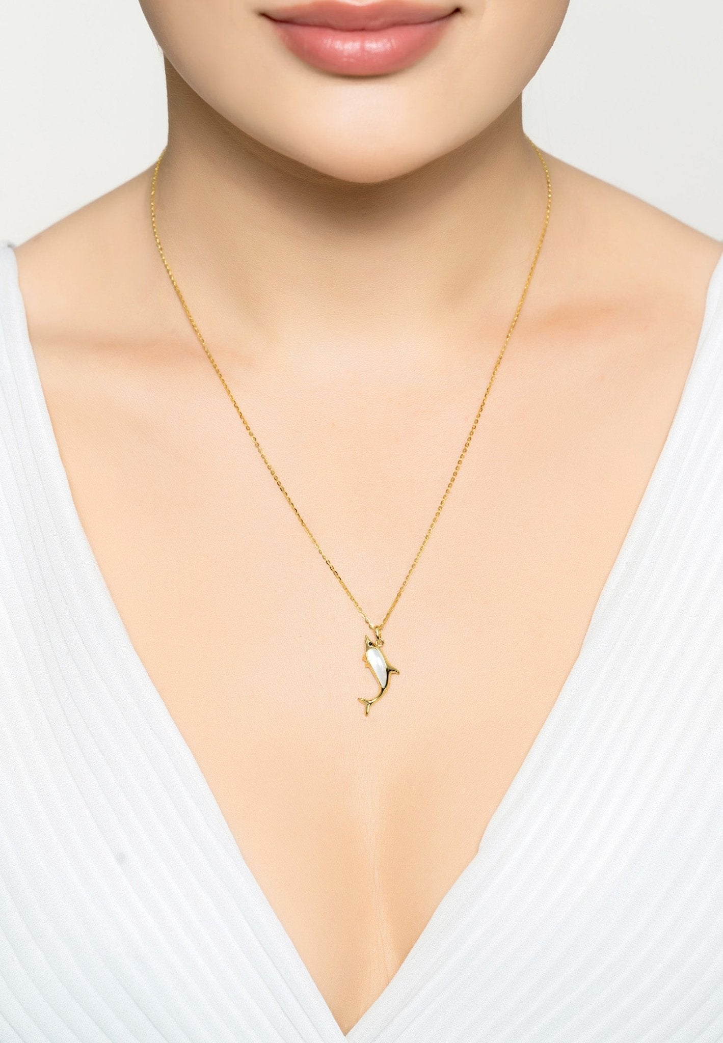 Dolphin Pearl Necklace Gold featuring a playful dolphin design with a teardrop-shaped pearl, elegantly crafted in 925 sterling silver and 18ct gold.