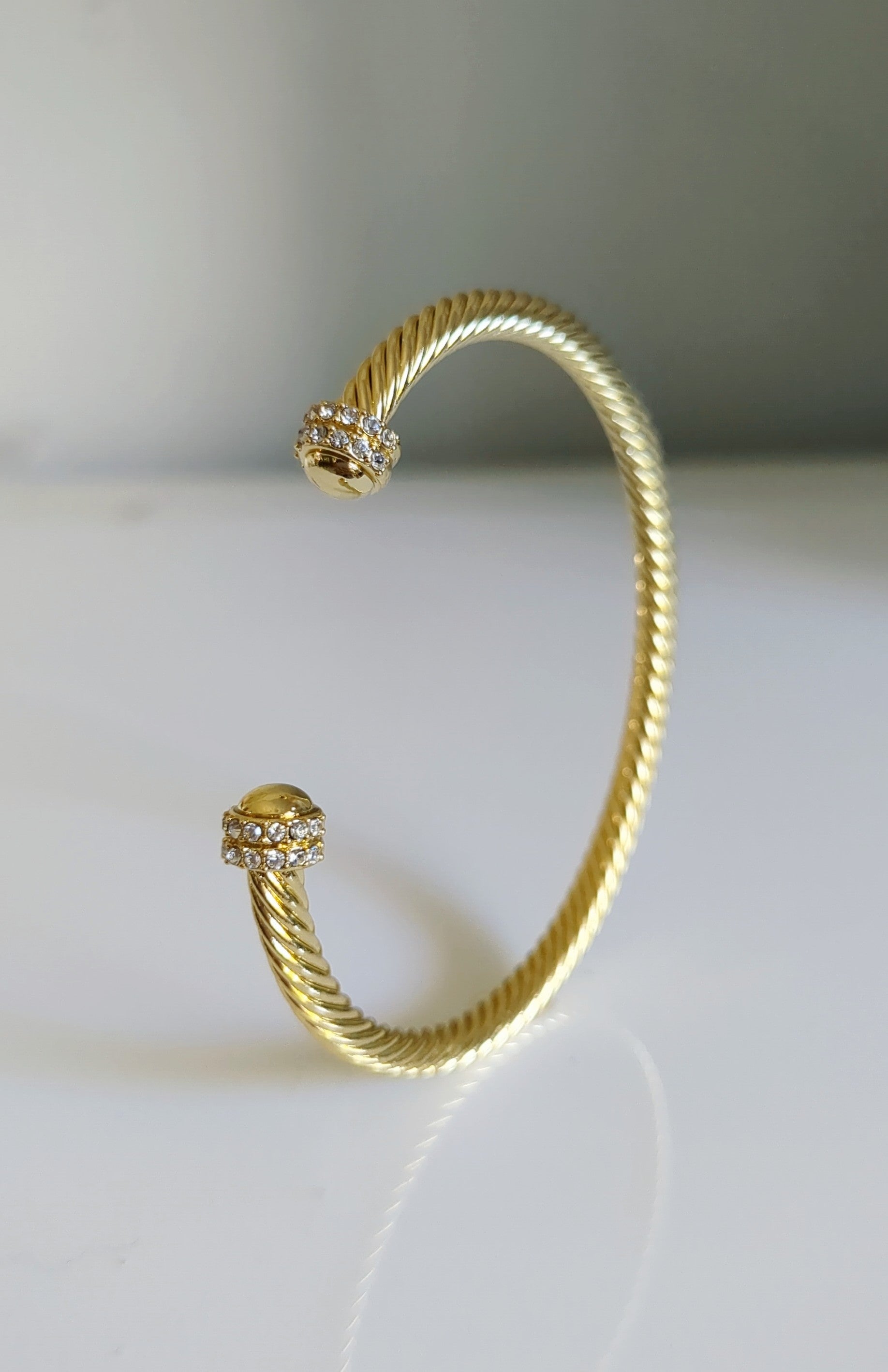 Elegant Dome Crystals Bangle featuring 18K Gold Filled material with a gold dome pattern and simulated diamonds, perfect for stacking.