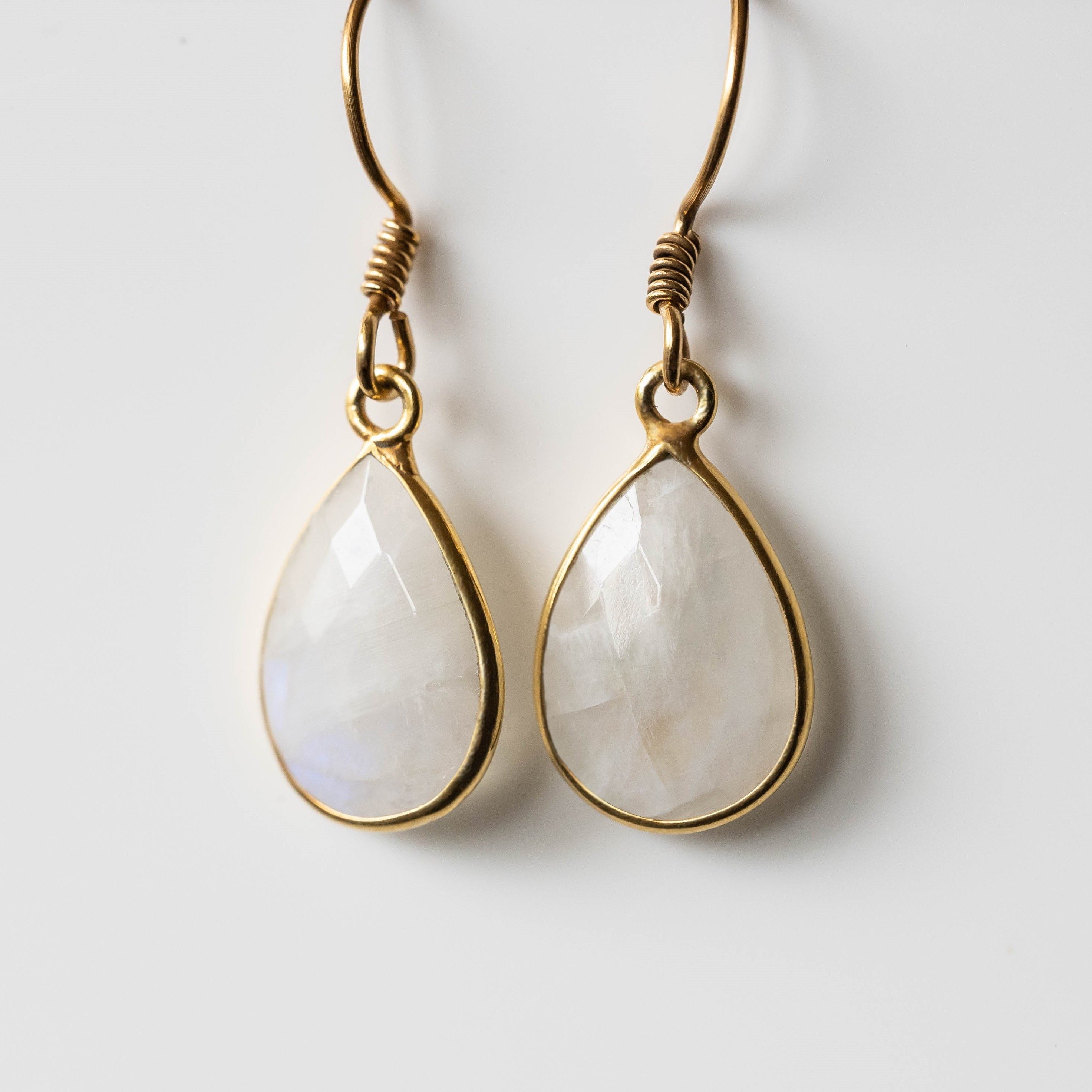 Elegant Donna Moonstone Tear-Drop Earrings in gold with 14mm gemstones, showcasing unique handmade design.