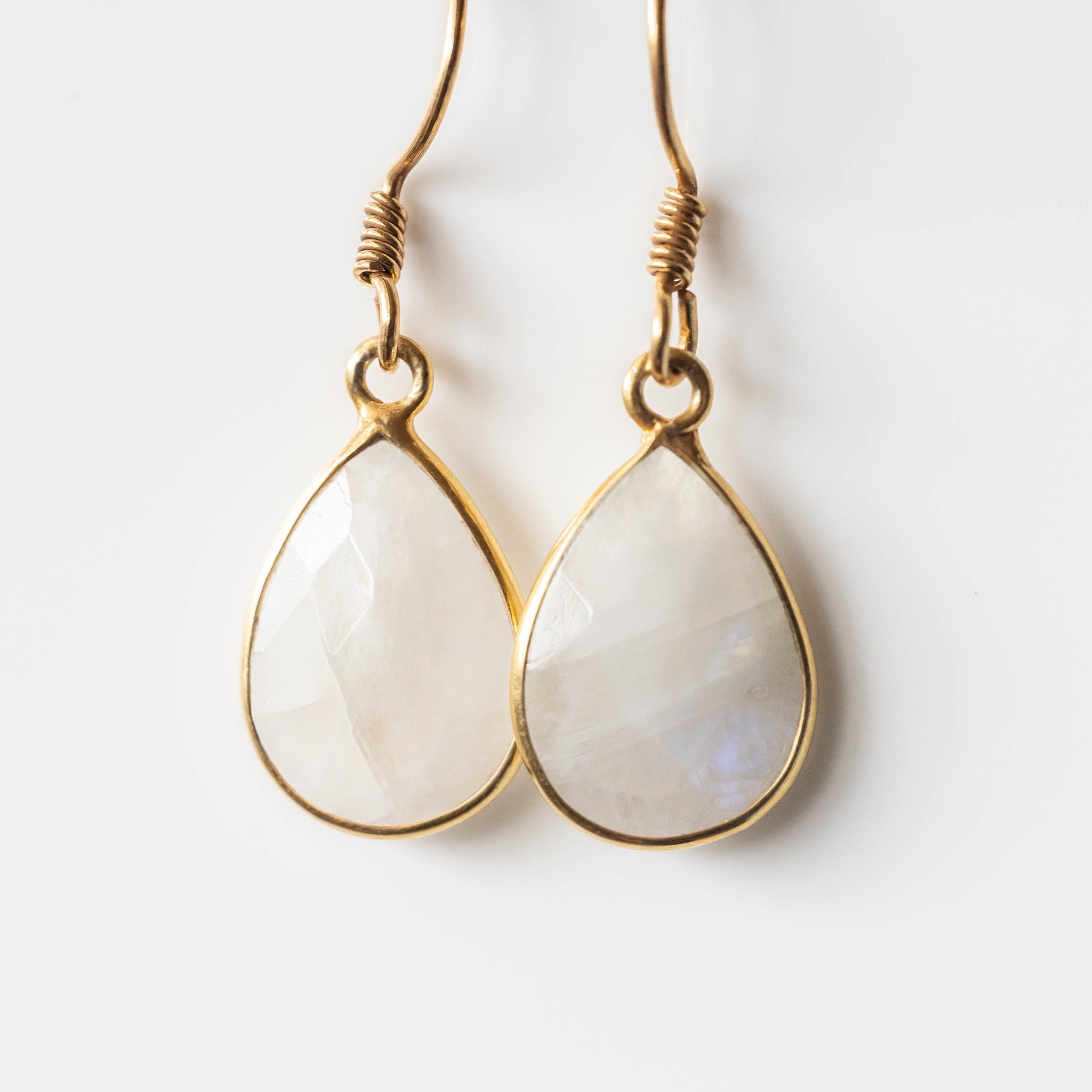 Elegant Donna Moonstone Tear-Drop Earrings in gold with 14mm gemstones, showcasing unique handmade design.