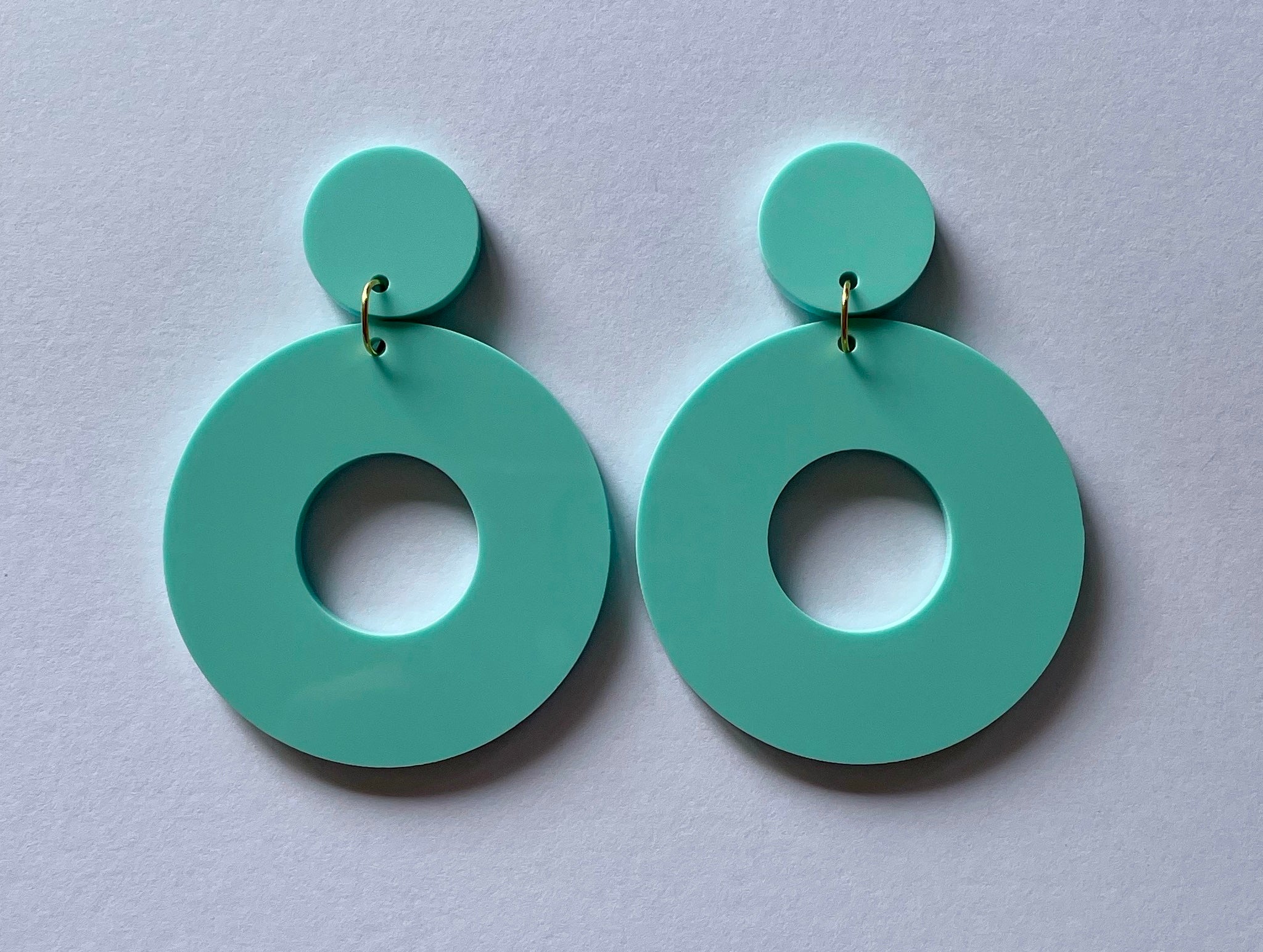 Colorful acrylic Donut Ring Earrings showcasing a retro design, available in multiple colors and styles.