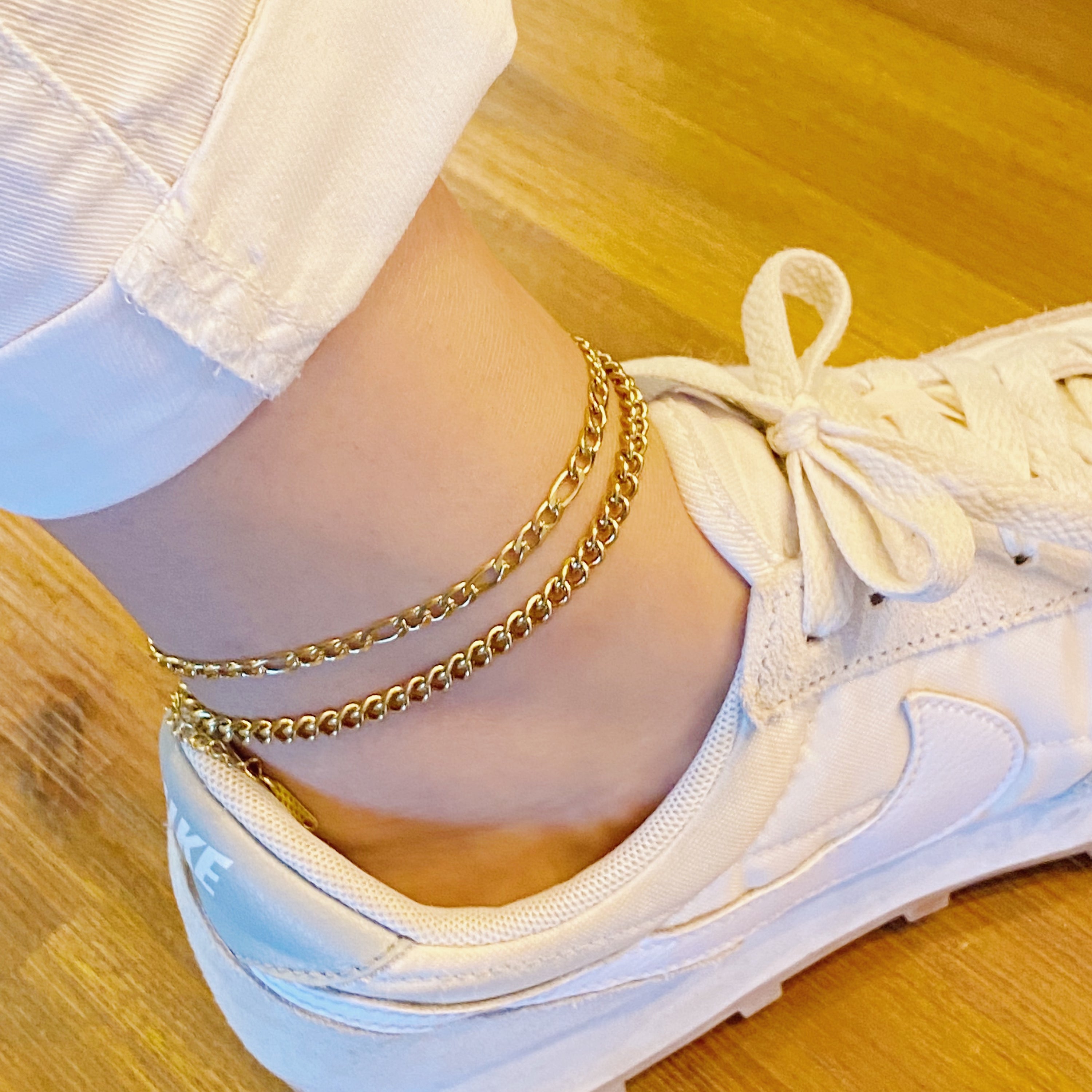 Stylish double chain anklet with gold plated stainless steel, featuring two chains of different lengths for a unique look.