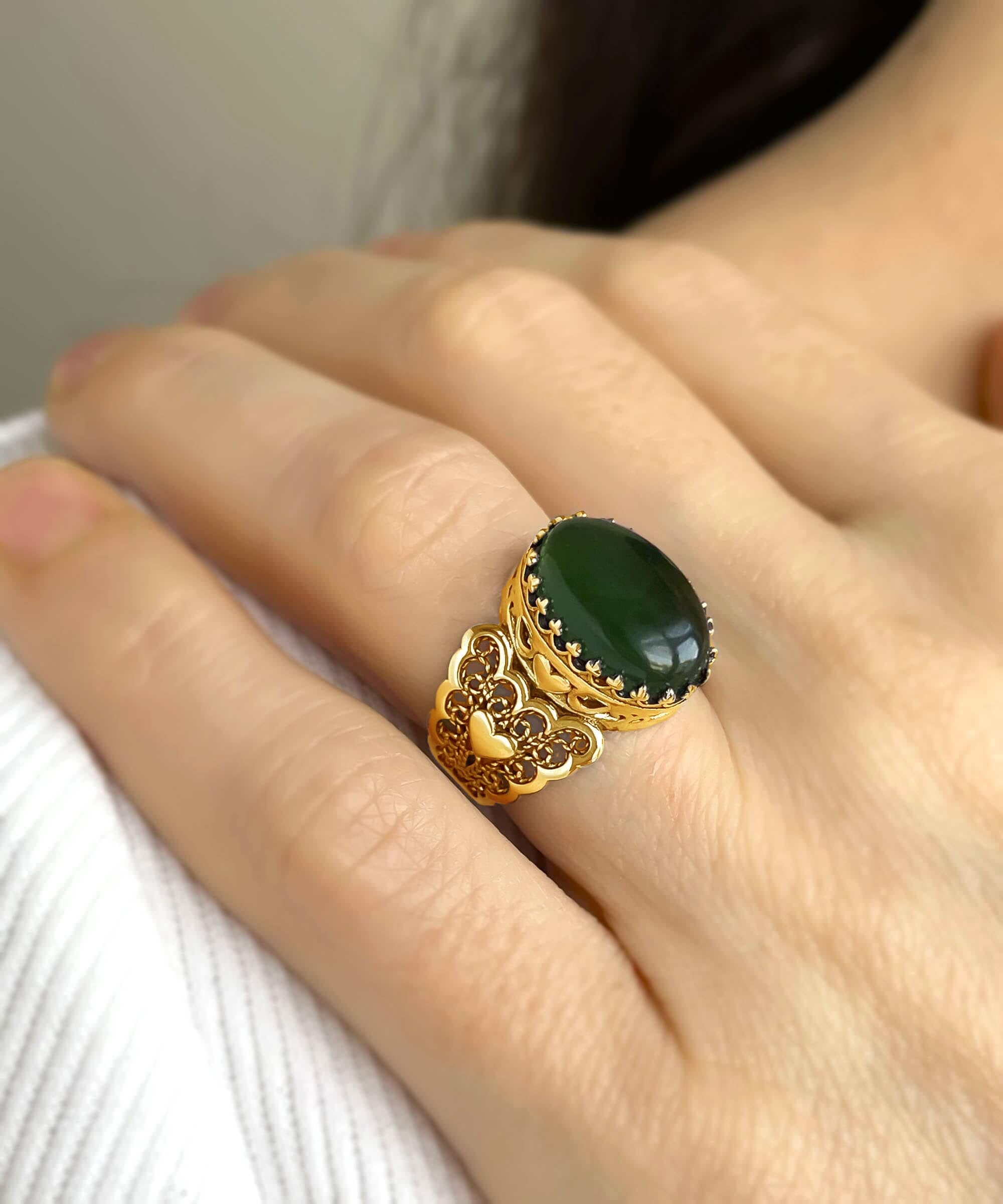 Elegant gold plated cocktail ring featuring double heart design and natural serpentine gemstone, presented in a luxurious gift box.