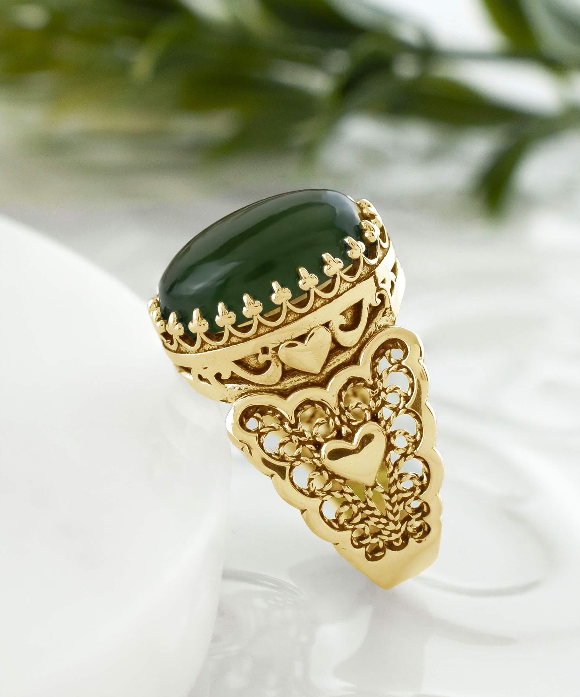 Elegant gold plated cocktail ring featuring double heart design and natural serpentine gemstone, presented in a luxurious gift box.