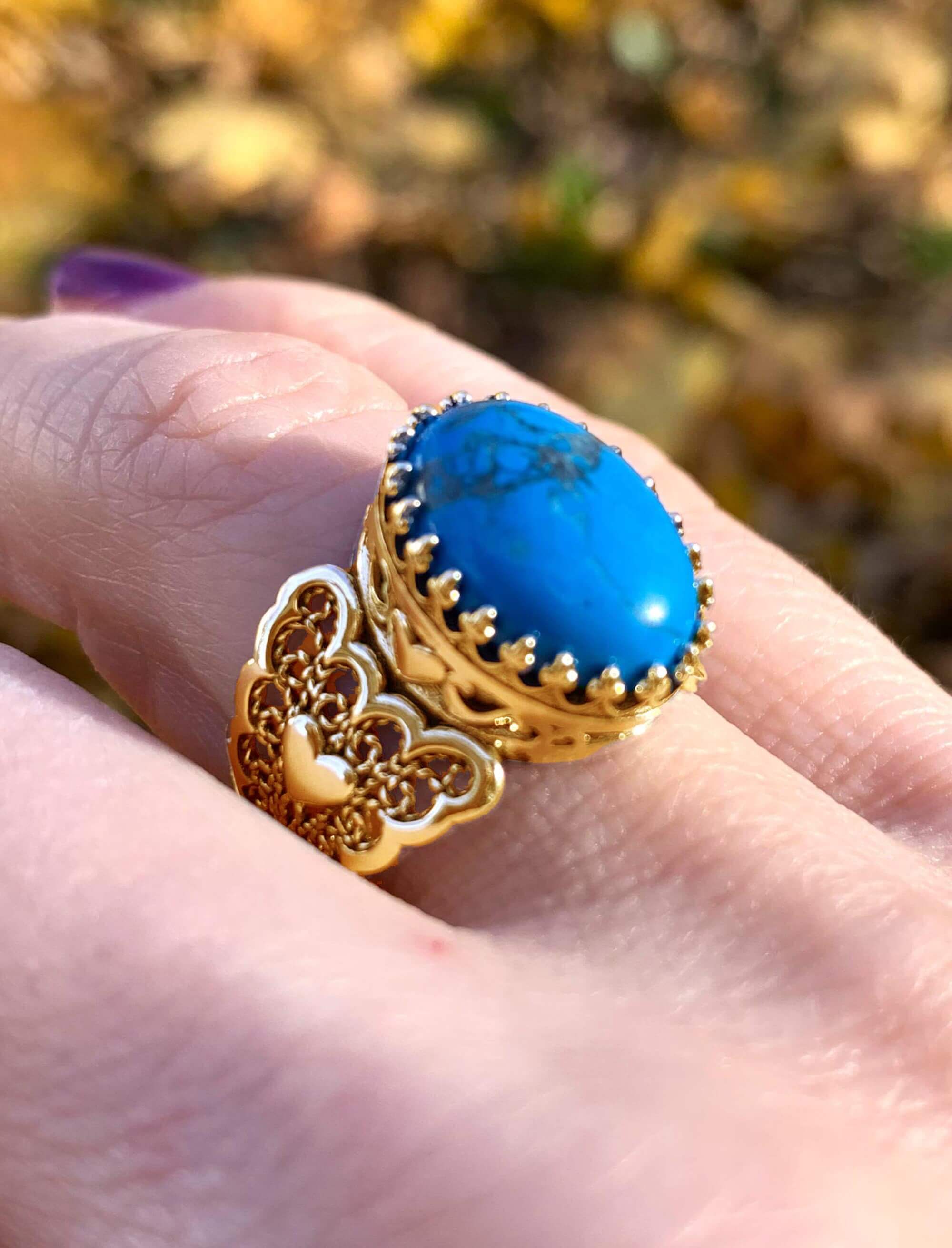 Double Heart Detailed Turquoise Gemstone Filigree Art Gold Plated ring showcasing intricate design and vibrant turquoise stone.