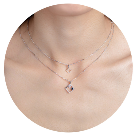 A beautiful double layer necklace featuring sparkling Swarovski elements, designed with a geometric pattern and adjustable clavicle chain.