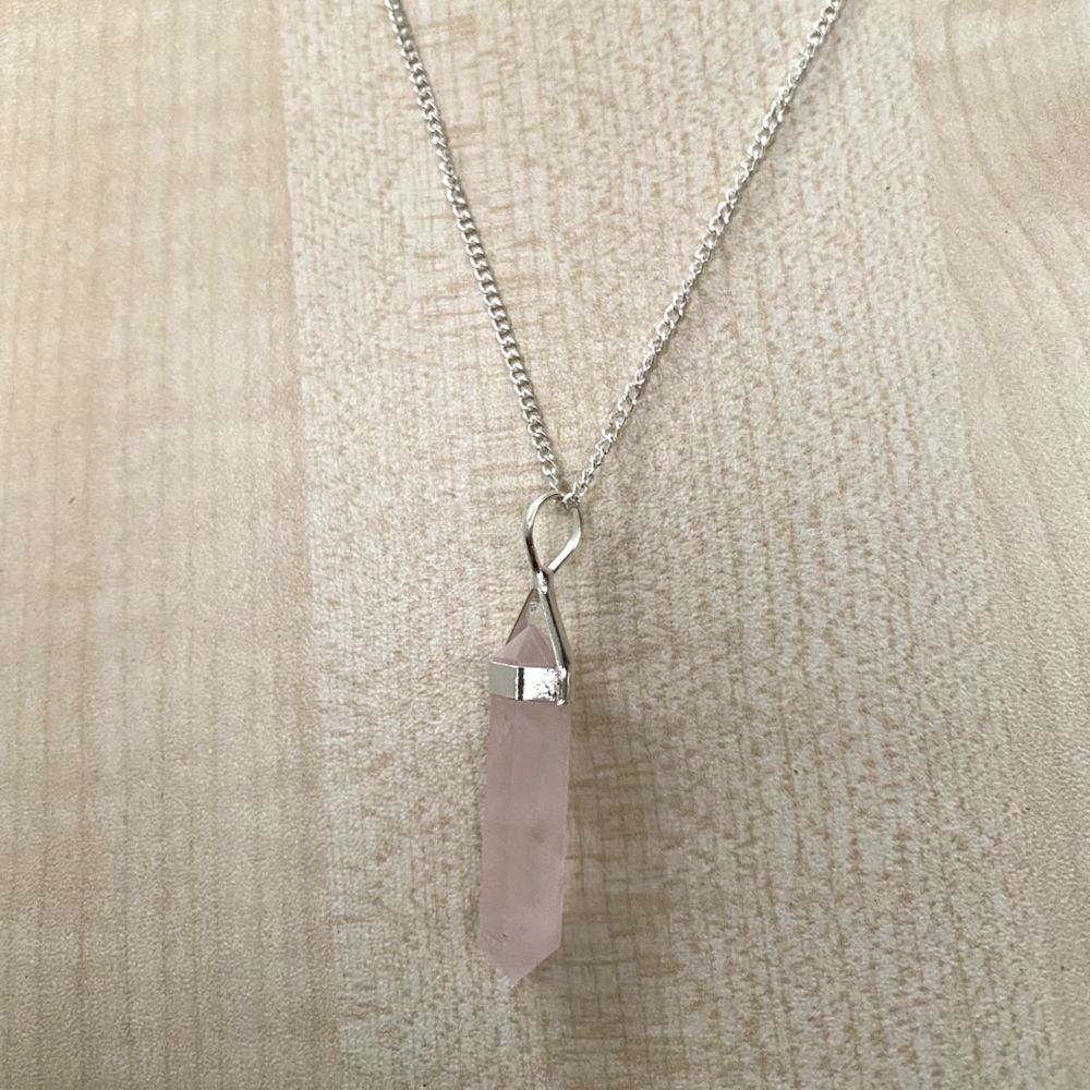 A beautiful Double Point Pencil Pendant made of semi-precious gemstones, showcasing its unique shape and vibrant colors, hanging from a durable alloy chain.