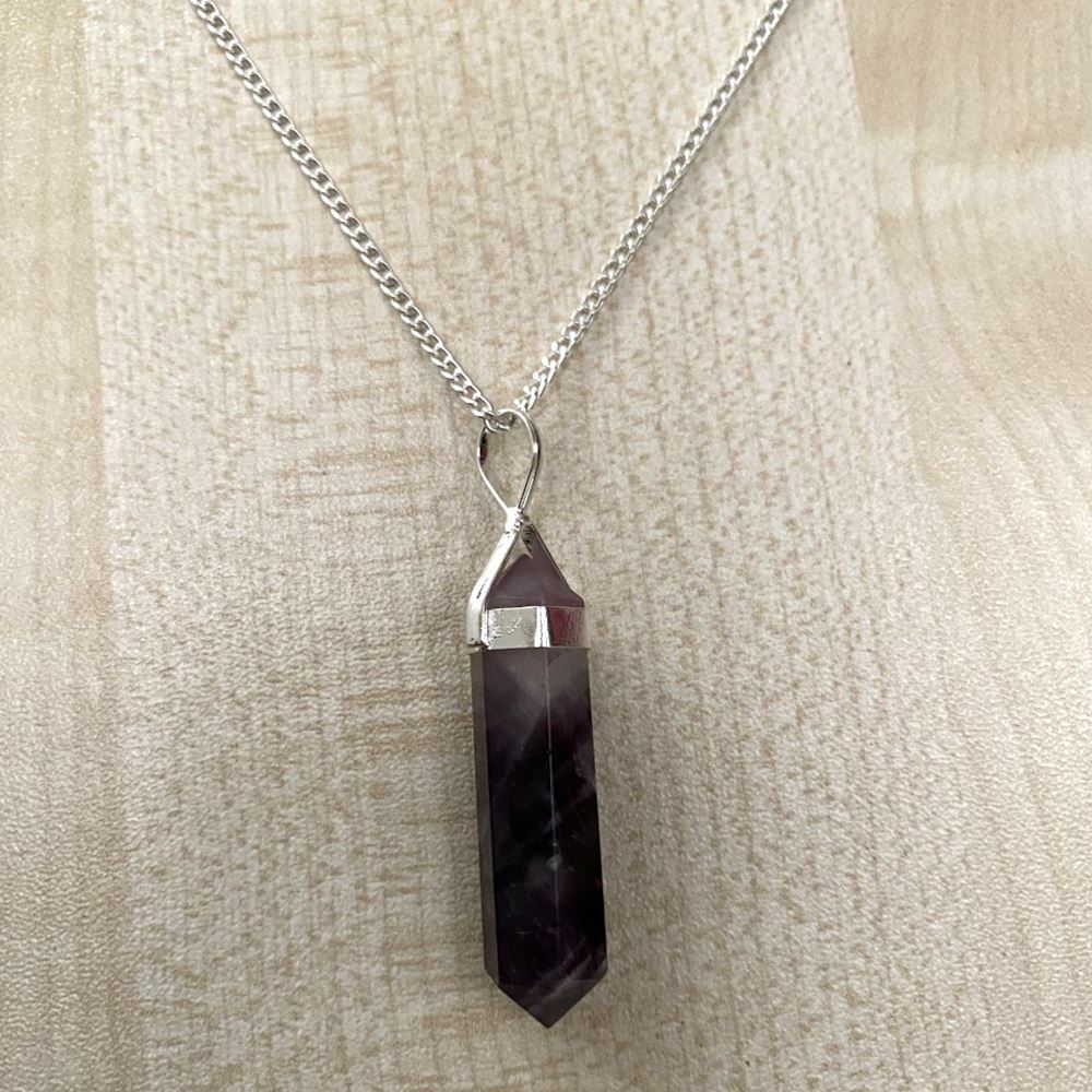 A beautiful Double Point Pencil Pendant made of semi-precious gemstones, showcasing its unique shape and vibrant colors, hanging from a durable alloy chain.