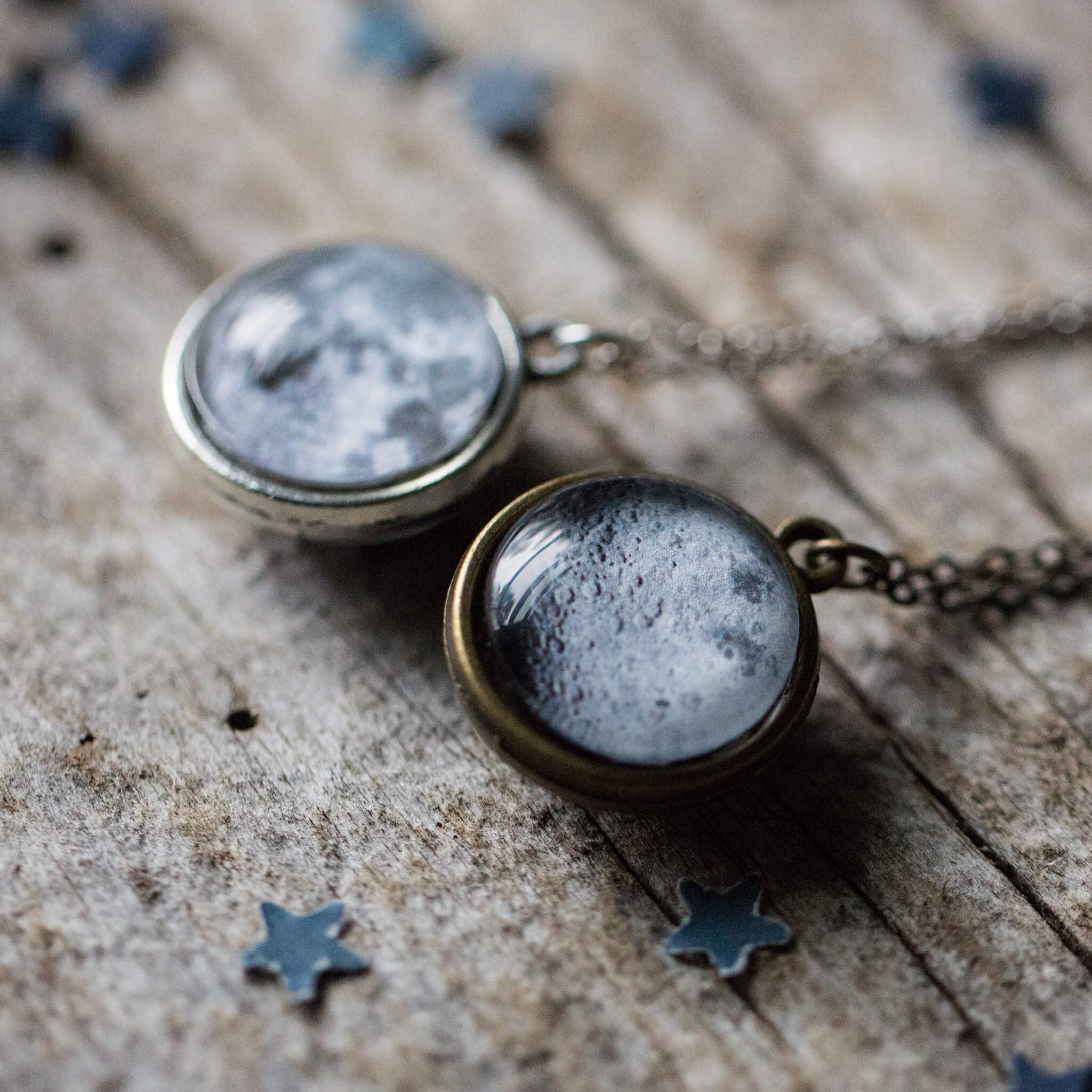 Double Sided Moon Necklace featuring the moon's face and dark side, available in antique bronze and silver tones.