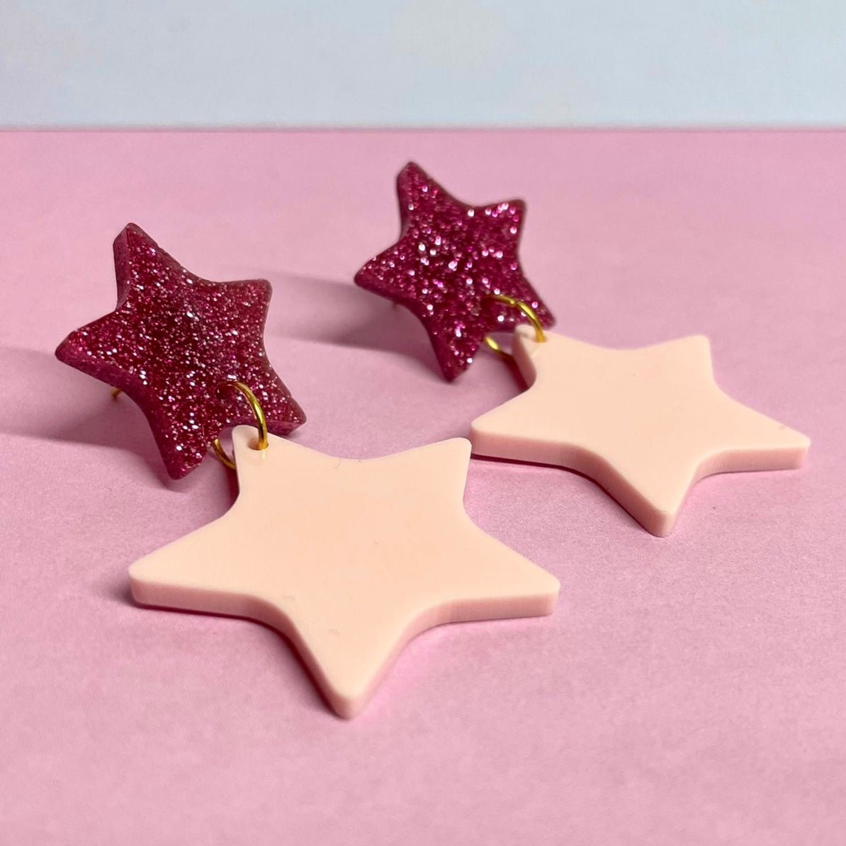 A pair of elegant Double Star Dangle Earrings made from laser-cut acrylic, featuring a unique design with a height of 5.5cm and width of 3.25cm.