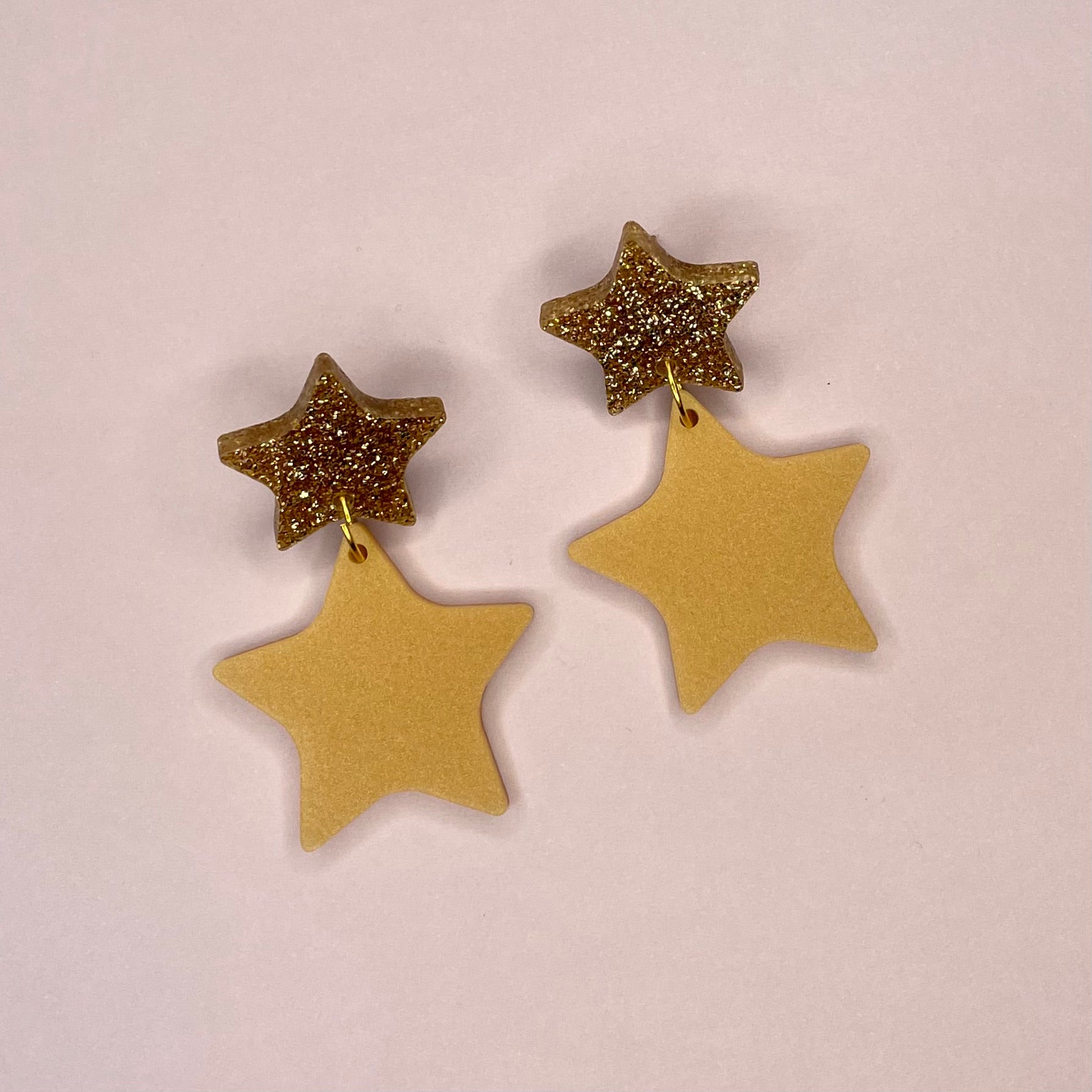 A pair of elegant Double Star Dangle Earrings made from laser-cut acrylic, featuring a unique design with a height of 5.5cm and width of 3.25cm.