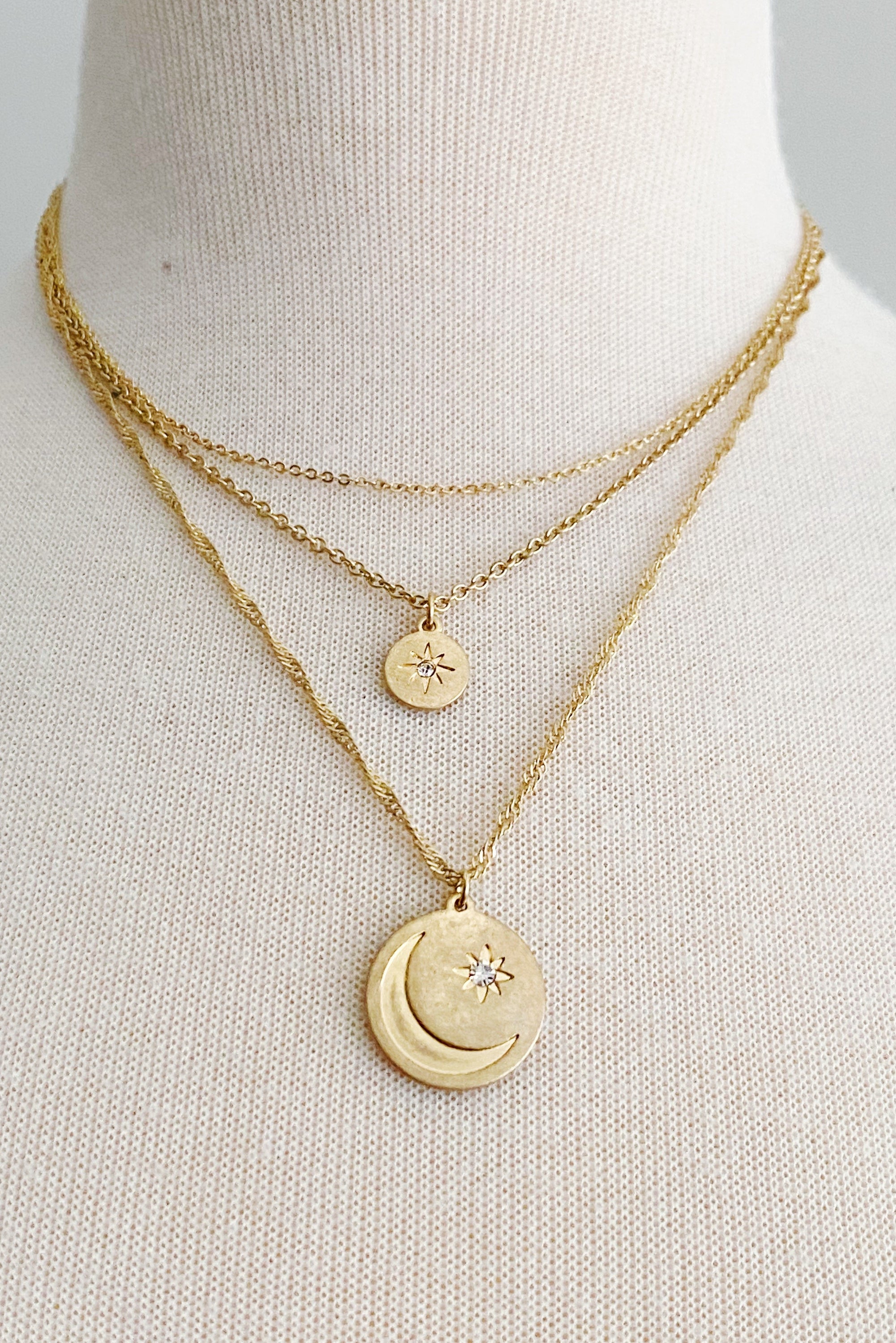 Double Star Layered Necklace featuring three chains with worn gold finish charms, adjustable length, and stylish design.