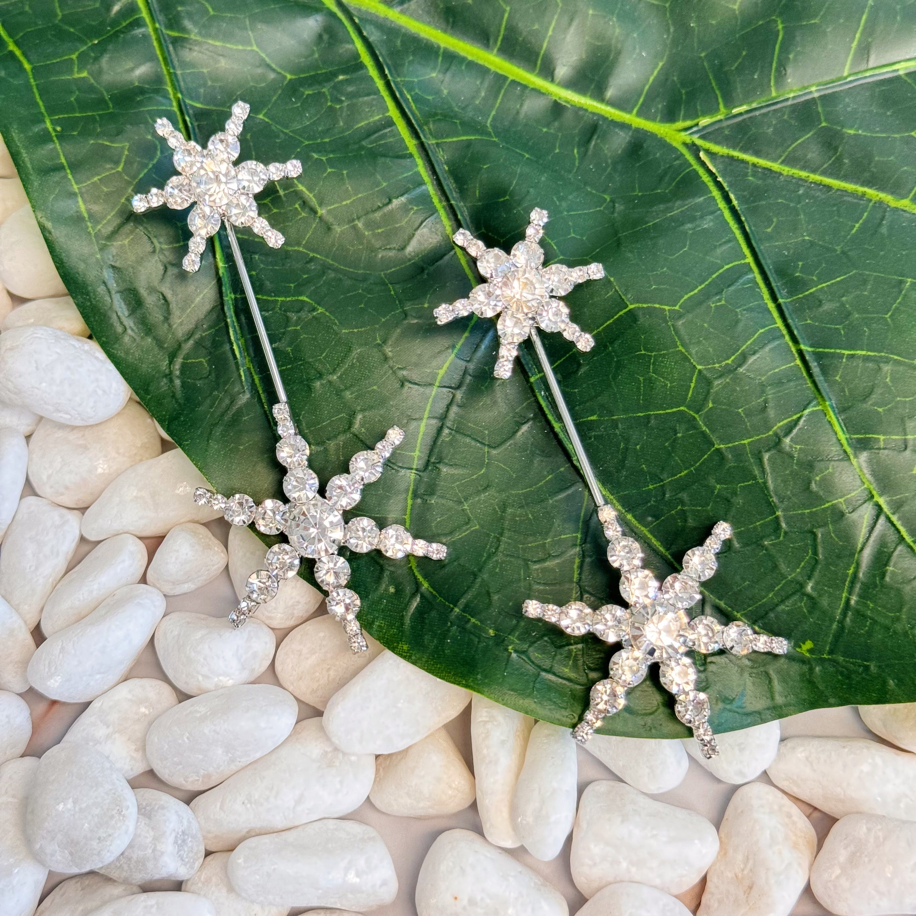 Elegant Double Starburst Statement Earrings featuring a sparkly starburst design in 18k gold plated brass with glass stones.