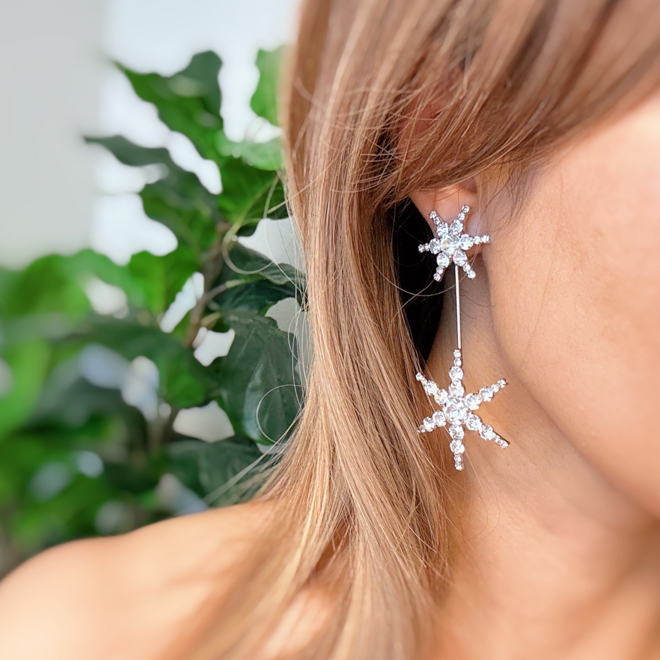 Elegant Double Starburst Statement Earrings featuring a sparkly starburst design in 18k gold plated brass with glass stones.