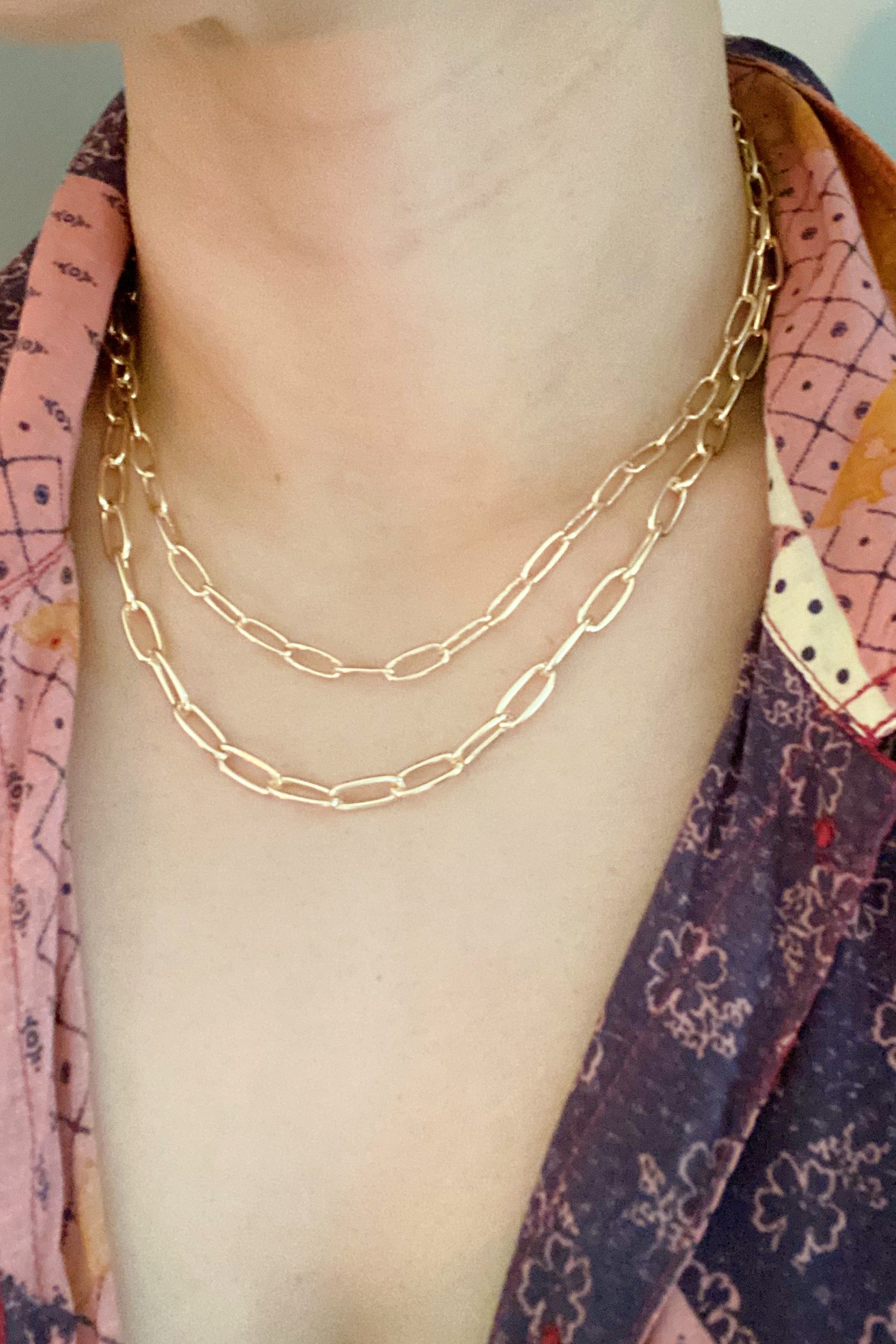 Double layered gold chain link necklace with a slimmer first layer and thicker second layer, featuring a 3-inch extender.