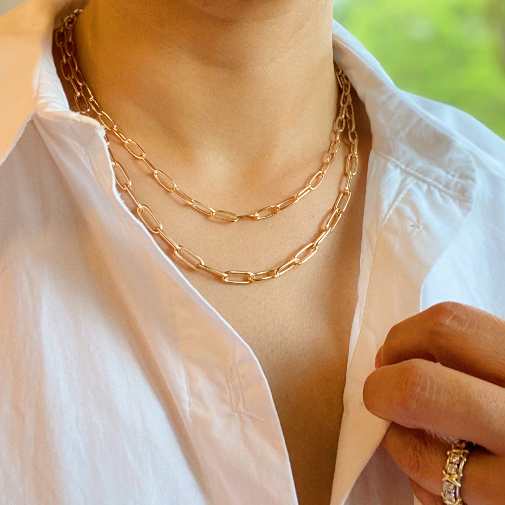 Double layered gold chain link necklace with a slimmer first layer and thicker second layer, featuring a 3-inch extender.