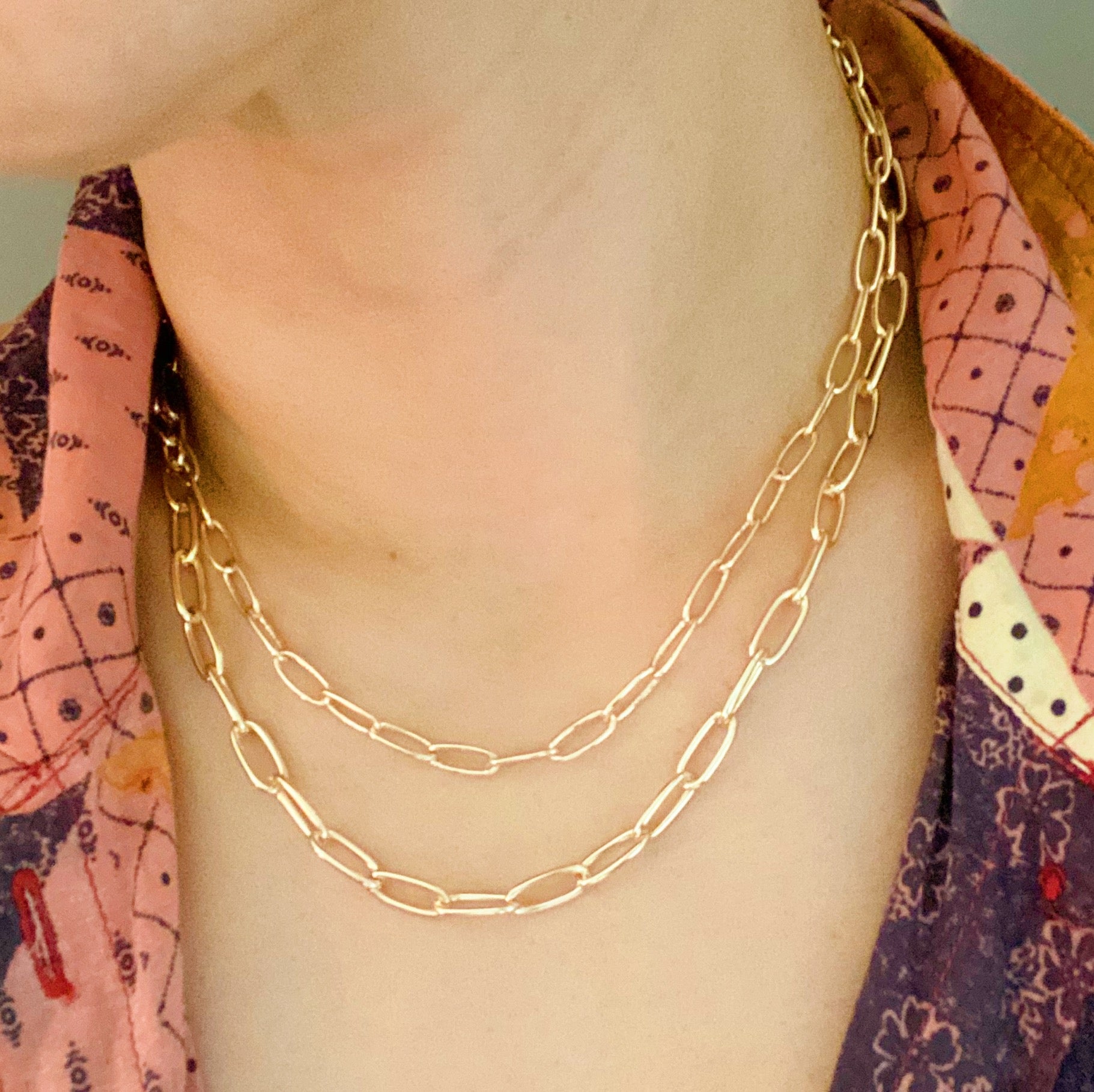 Double layered gold chain link necklace with a slimmer first layer and thicker second layer, featuring a 3-inch extender.