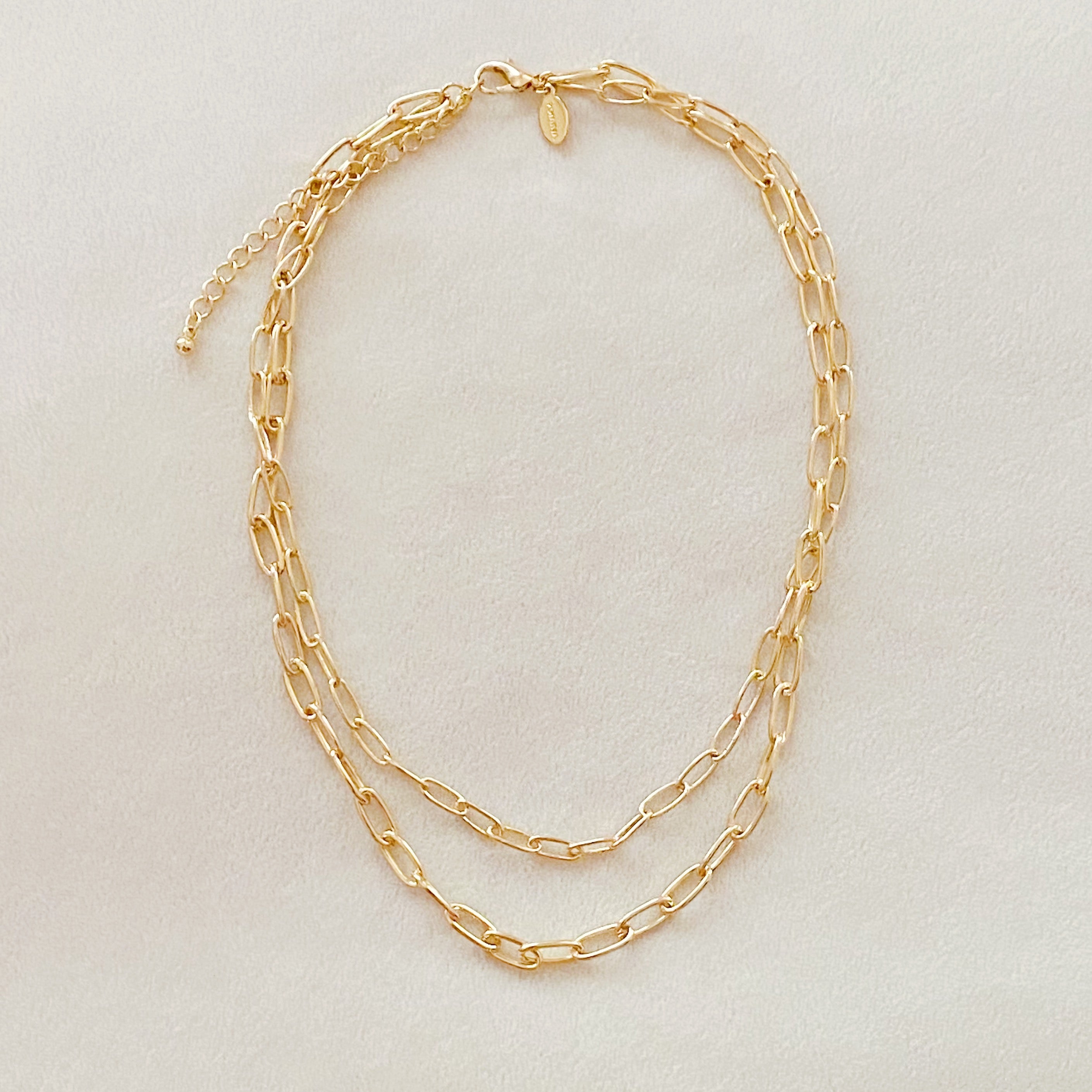 Double layered gold chain link necklace with a slimmer first layer and thicker second layer, featuring a 3-inch extender.