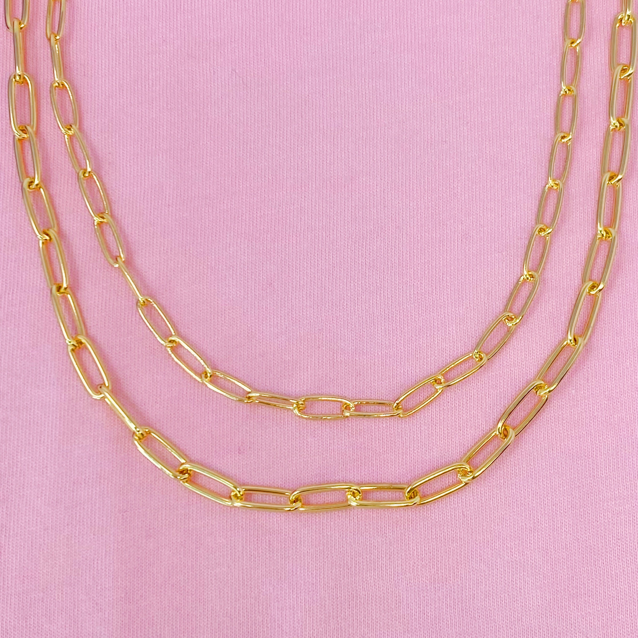 Double layered gold chain link necklace with a slimmer first layer and thicker second layer, featuring a 3-inch extender.