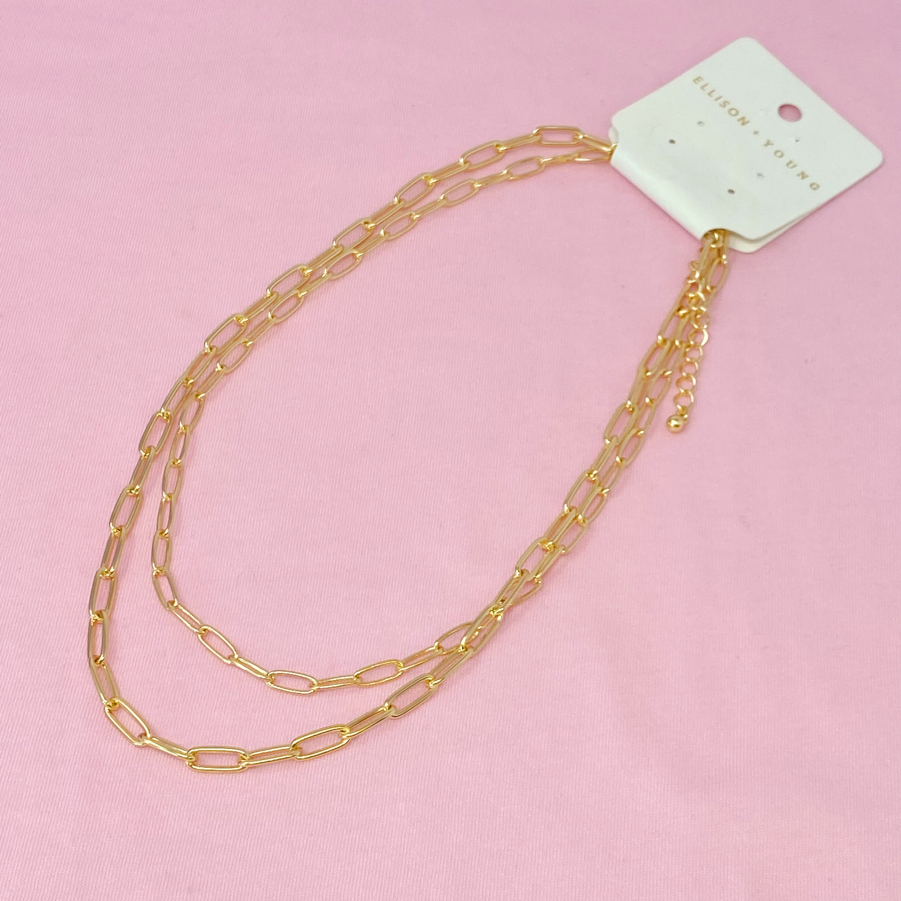 Double layered gold chain link necklace with a slimmer first layer and thicker second layer, featuring a 3-inch extender.