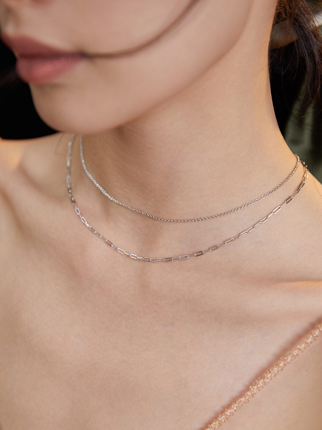 A stunning double-layered necklace made of gold vermeil, showcasing its elegant design and adjustable chain length.