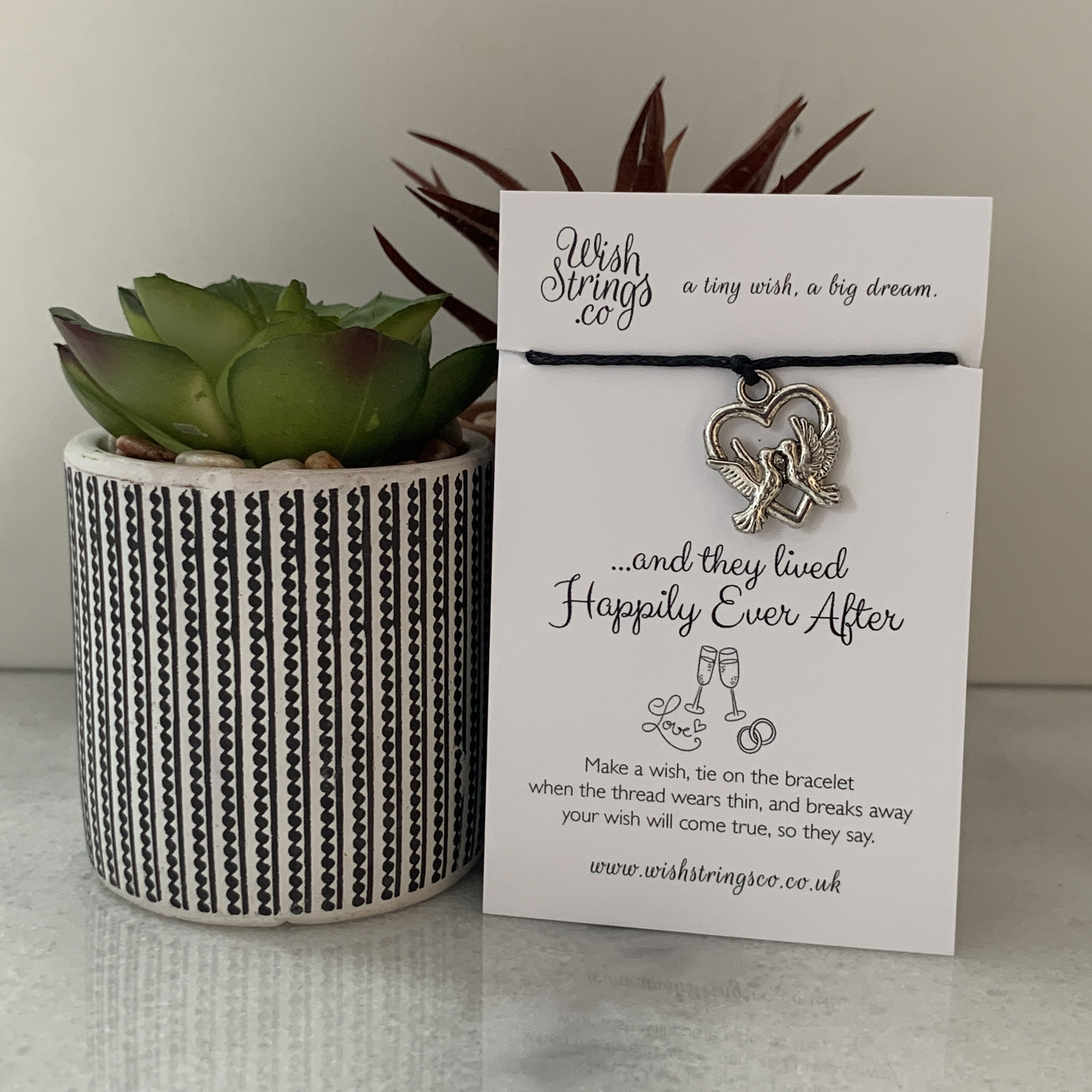 DOVE HEART WishStrings Wish Bracelet featuring a Tibetan Silver charm on a waxed cotton cord, beautifully presented on a luxury display card.