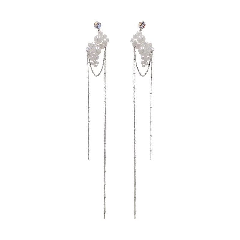 Dramatic earrings featuring pearls and crystals with long tassels, showcasing elegance and style.