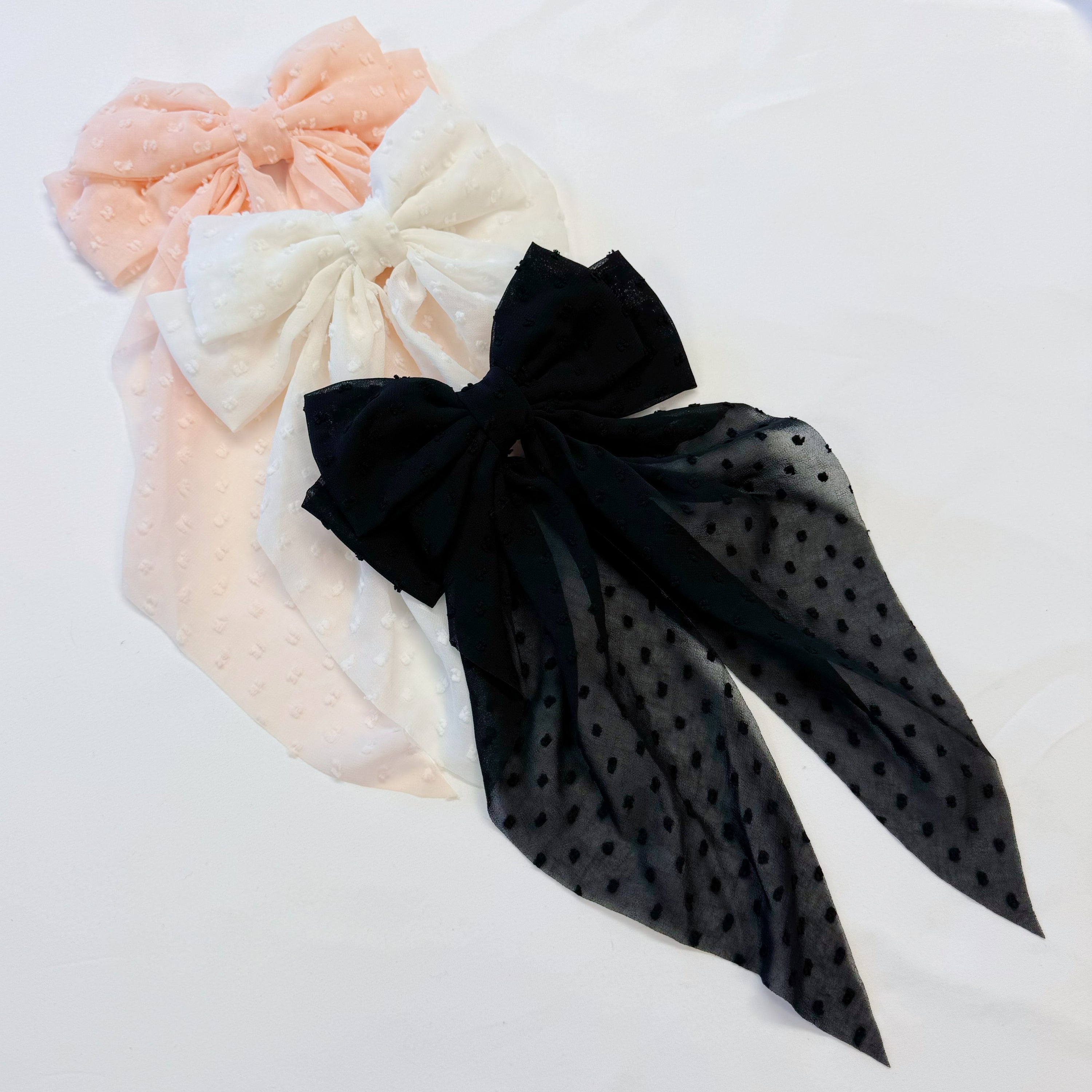 Dreamy Dotty Sheer Bow Hair Clip featuring a delicate sheer fabric and a playful dot pattern, perfect for adding elegance to any hairstyle.