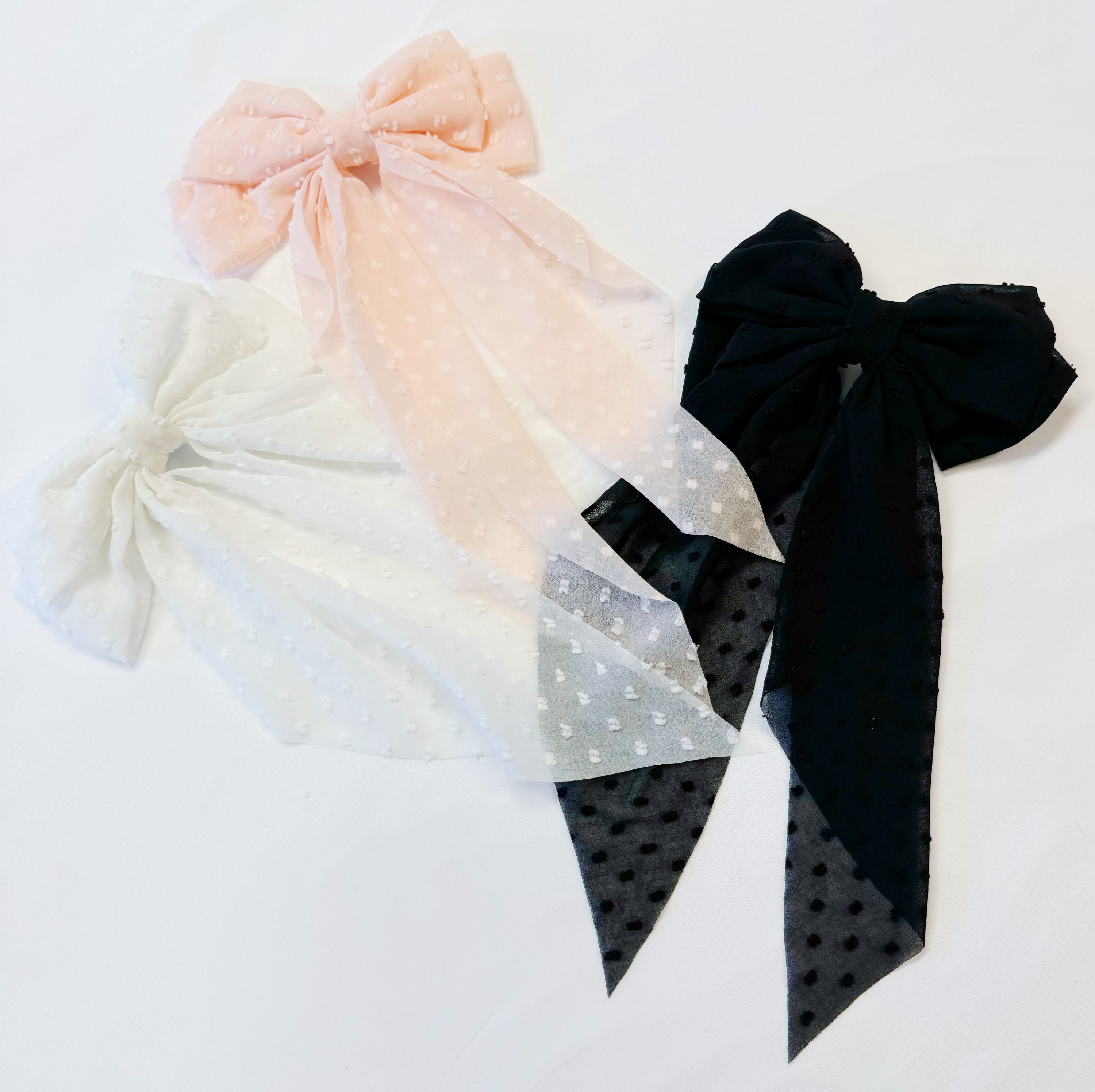 Dreamy Dotty Sheer Bow Hair Clip featuring a delicate sheer fabric and a playful dot pattern, perfect for adding elegance to any hairstyle.