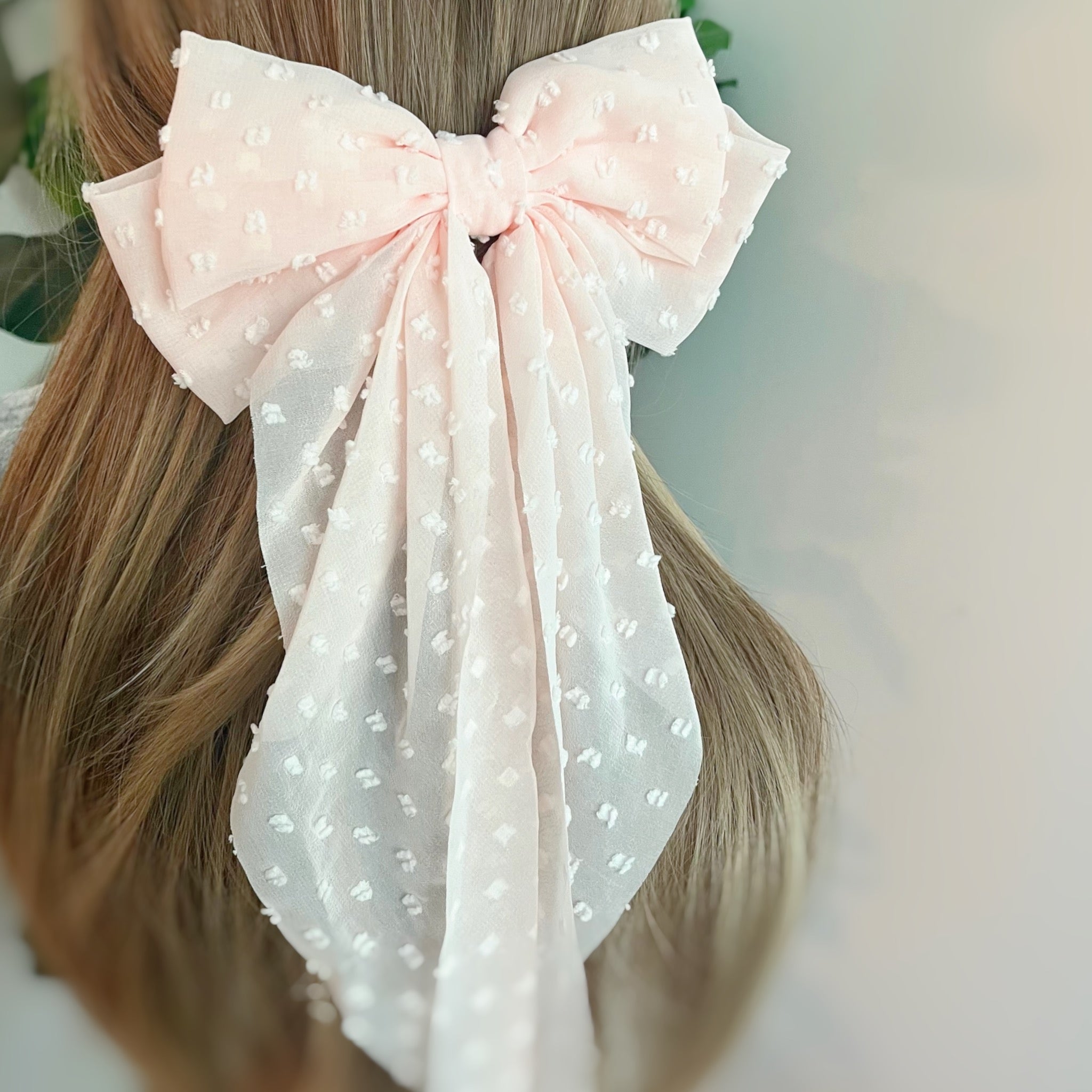 Dreamy Dotty Sheer Bow Hair Clip featuring a delicate sheer fabric and a playful dot pattern, perfect for adding elegance to any hairstyle.