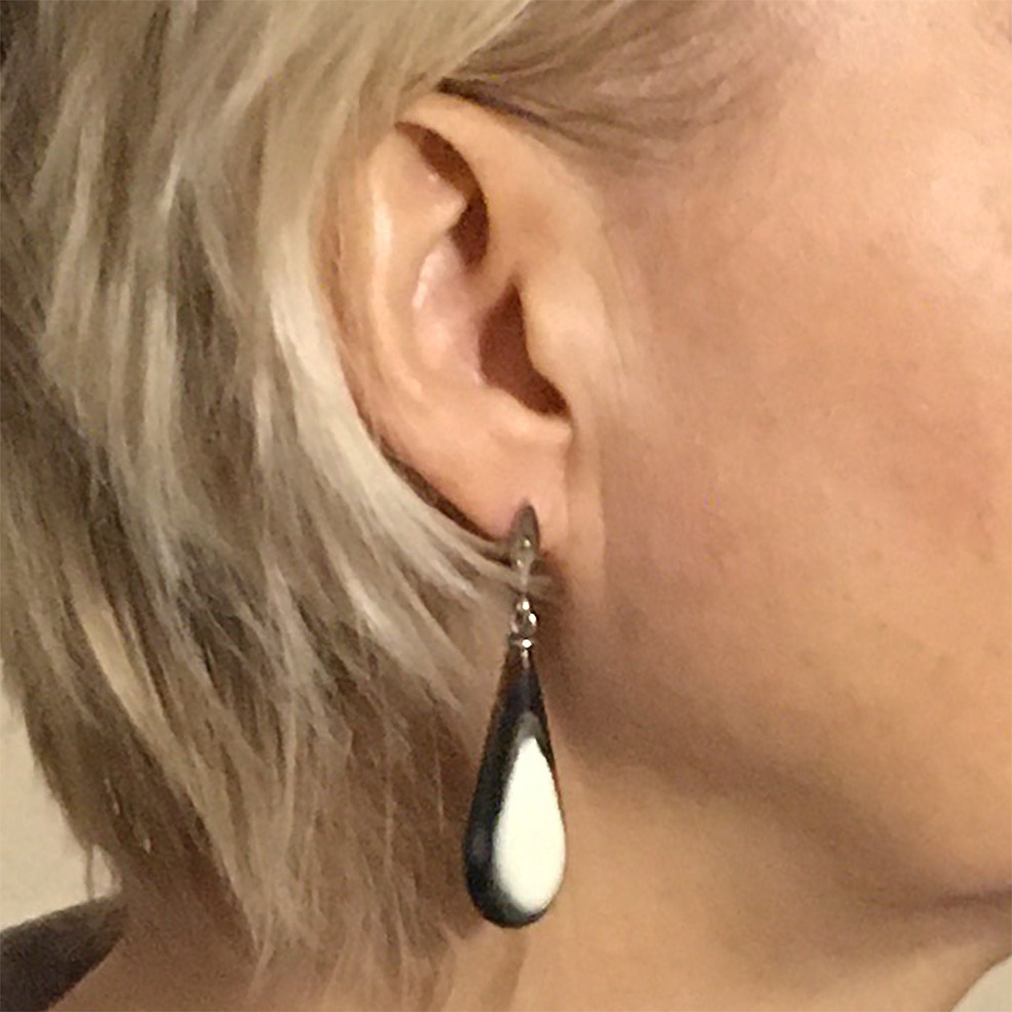 Elegant drop earrings made from natural buffalo horn with silver English locks, showcasing a unique color transition from gray-black to snow-white.