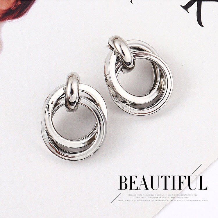 Elegant dual crossed earrings made from alloy and steel, featuring a stylish design perfect for any occasion.