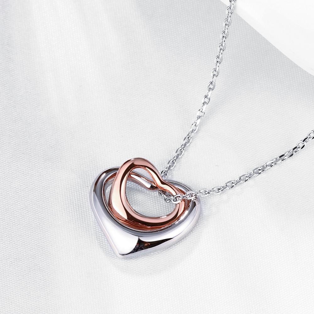 Duo Hearts Shaped pendant in 14K gold, featuring a delicate design and an 18-inch chain with a 2-inch extender.