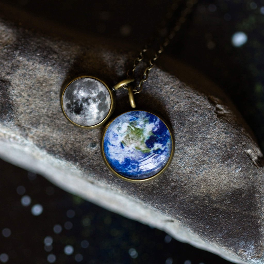 Earth and Moon Layered Space Necklace featuring a larger Earth pendant and a smaller Moon pendant, handcrafted with rhodium plated brass.